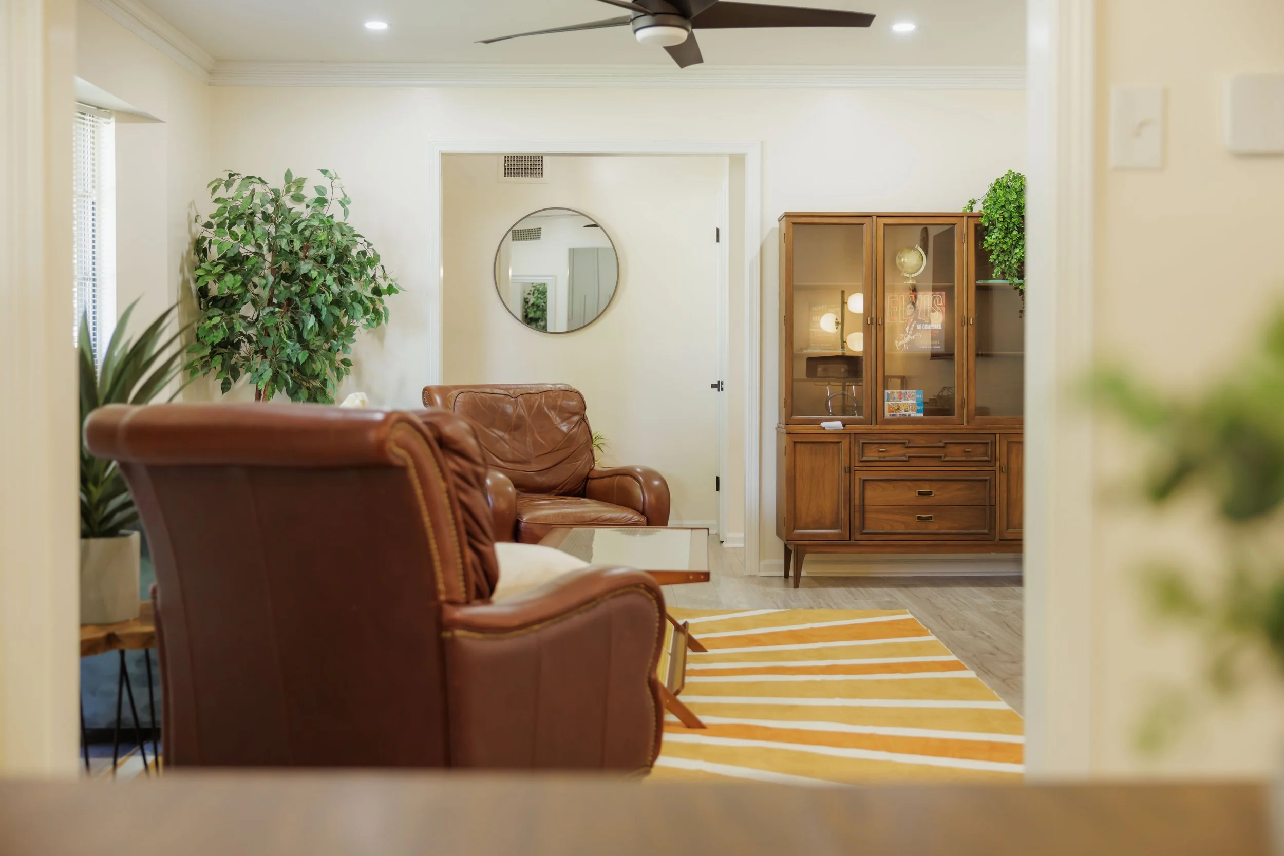 Warm mid-century inspired interiors with open sightlines throughout the home.