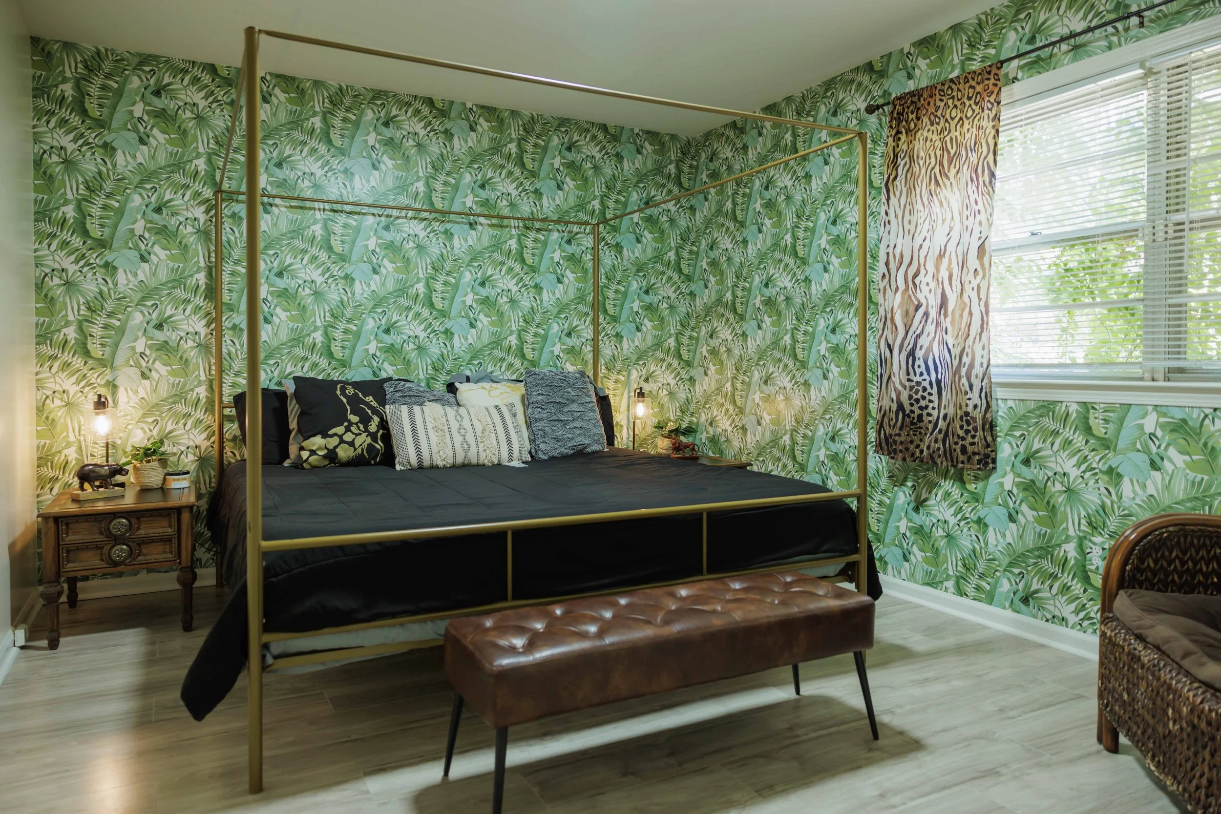 Spacious king bedroom with statement wallpaper, warm lighting, and thoughtful details designed for comfort and longer stays.