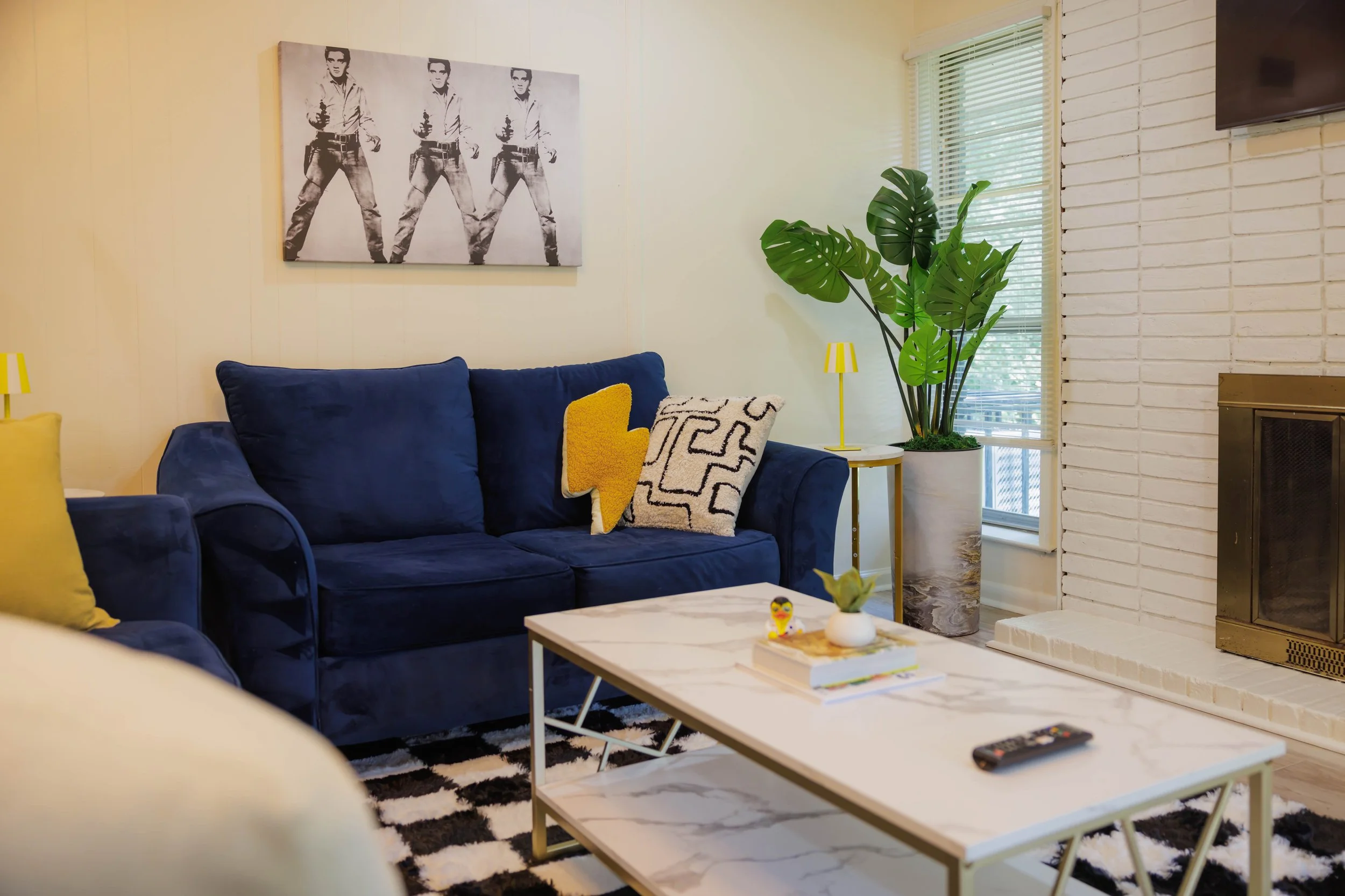 Comfortable gathering space with Memphis-inspired design details, a cozy fireplace, and room to unwind during extended stays in Memphis.