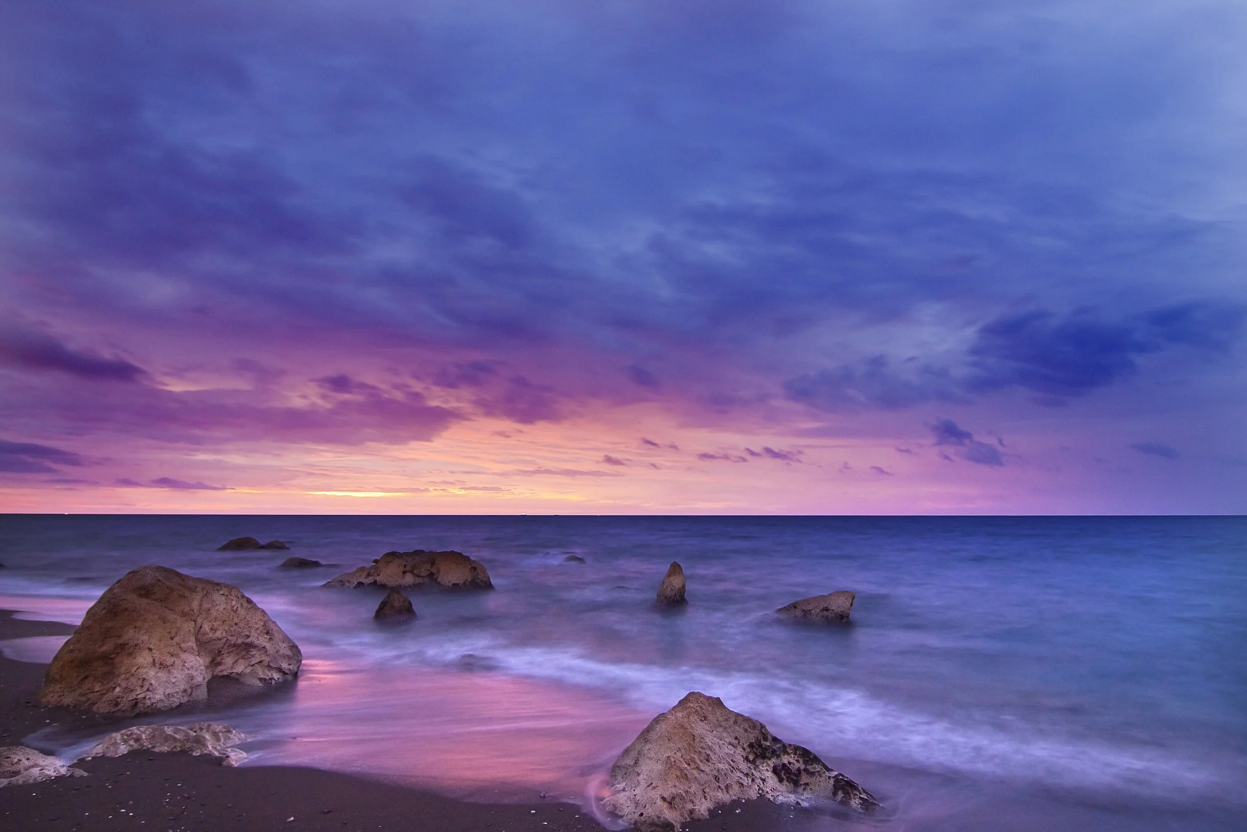 colorful beach sunset with purples, pinks, and blues