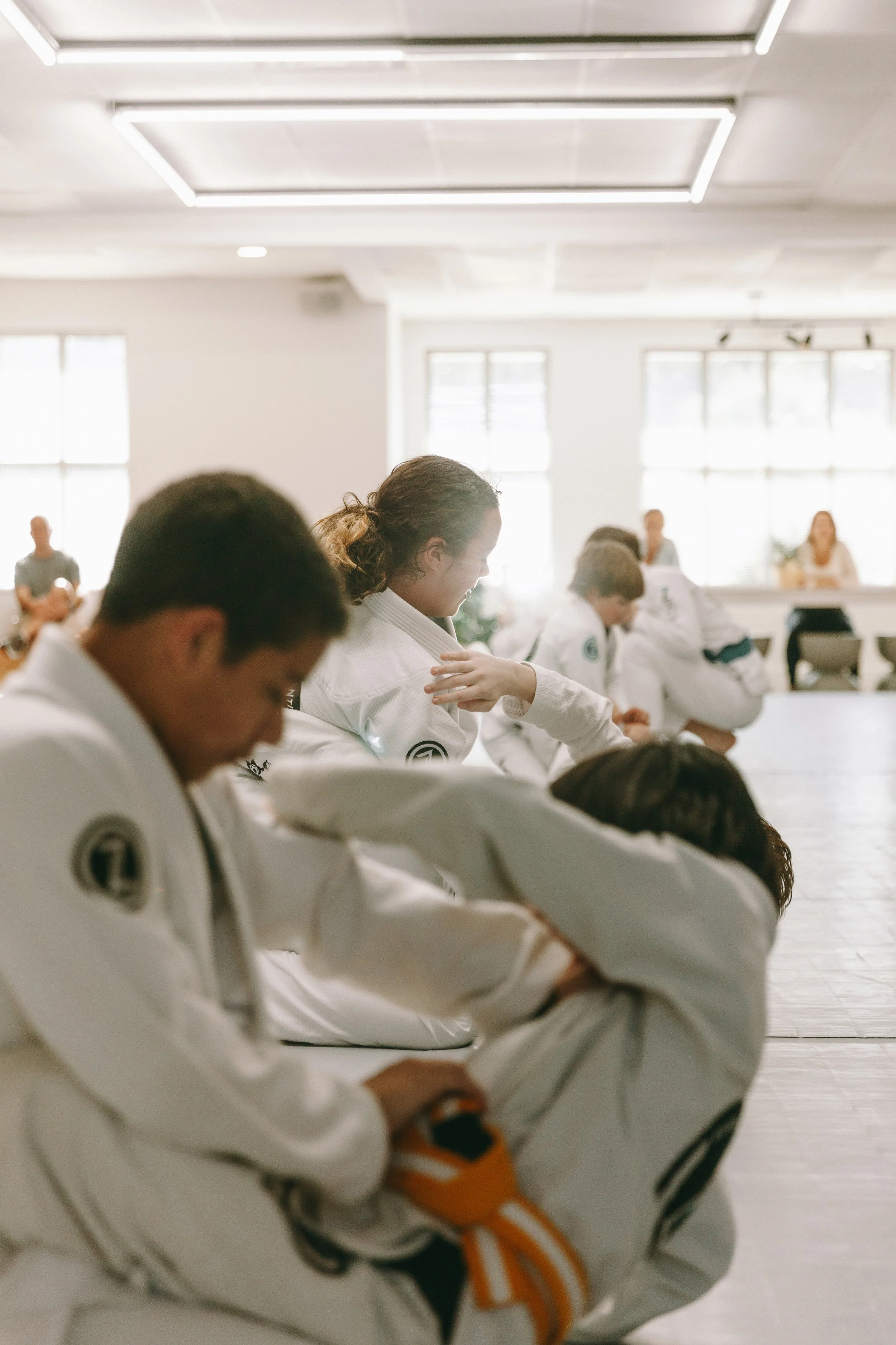 Kids practice Brazilian jiu-jitsu techniques on the mats at Houzn Jiu Jitsu Academy in Mount Pleasant, SC.