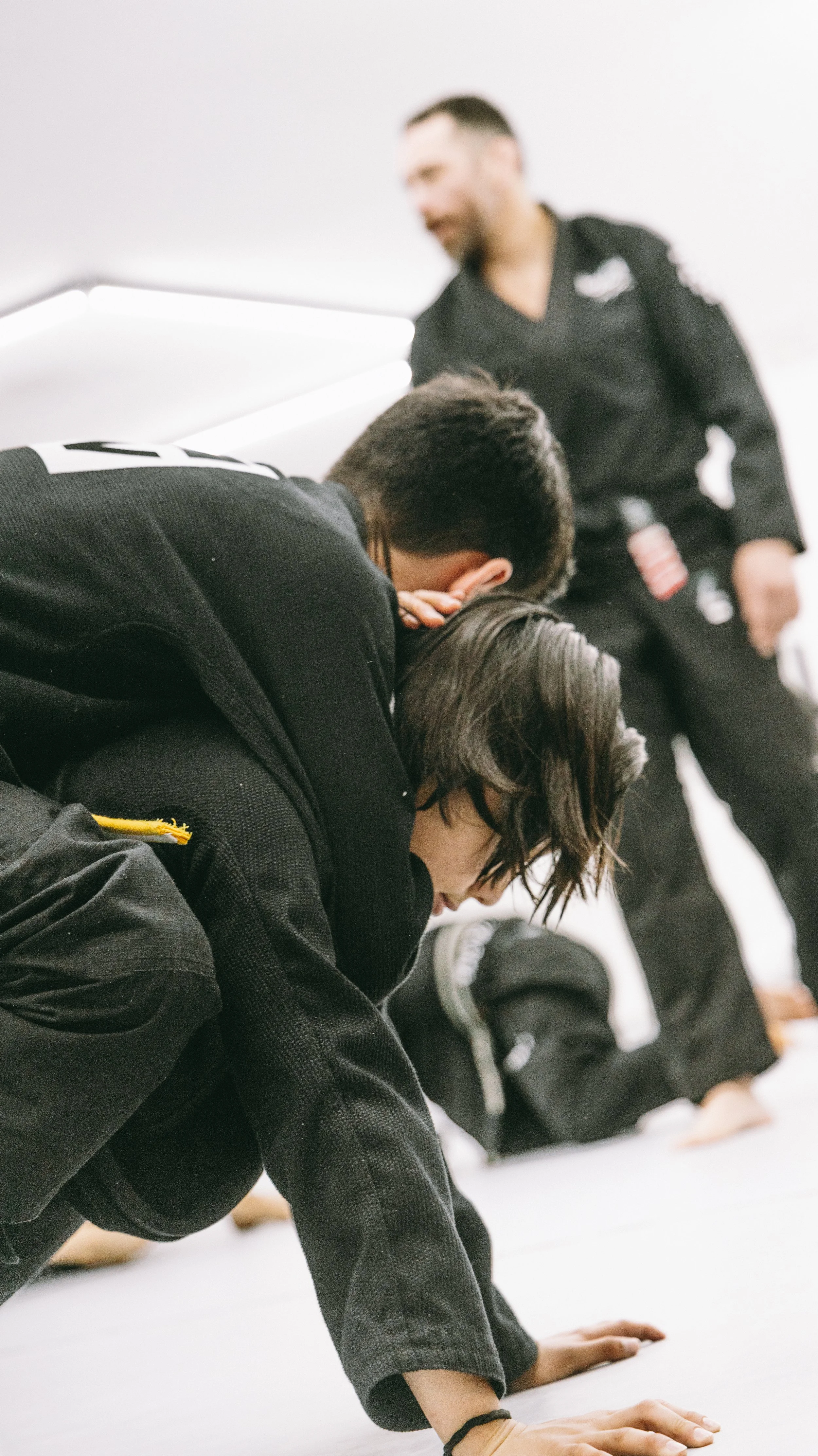 Kids practice Brazilian jiu jitsu drills with coach supervision at Houzn Jiu Jitsu Academy in Mount Pleasant, SC.