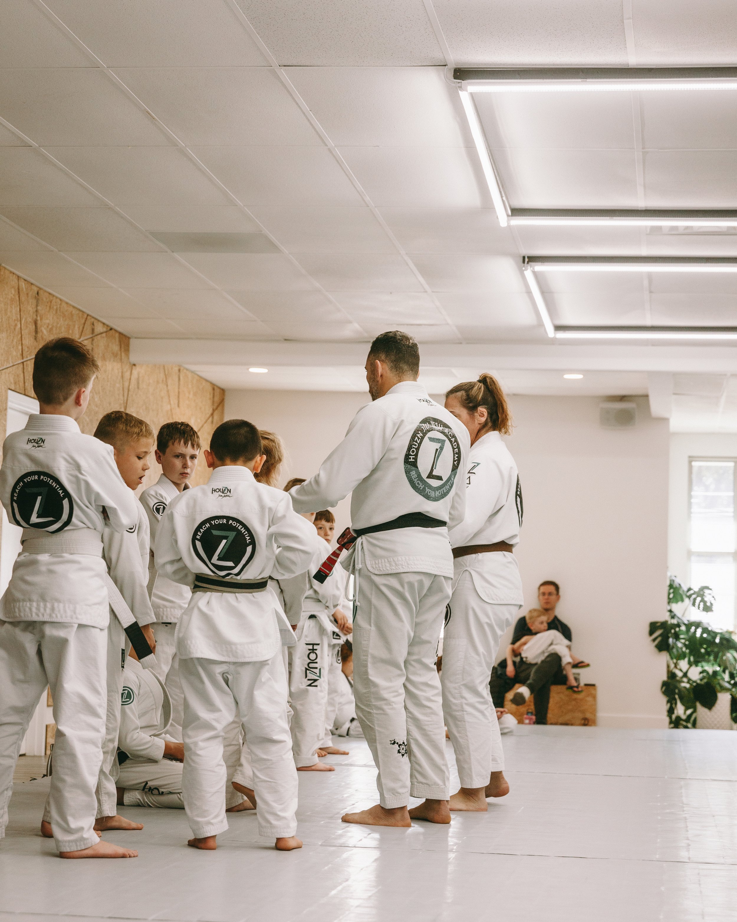 Kids line up and listen to coaches during class at Houzn Jiu Jitsu Academy in Mount Pleasant, SC.