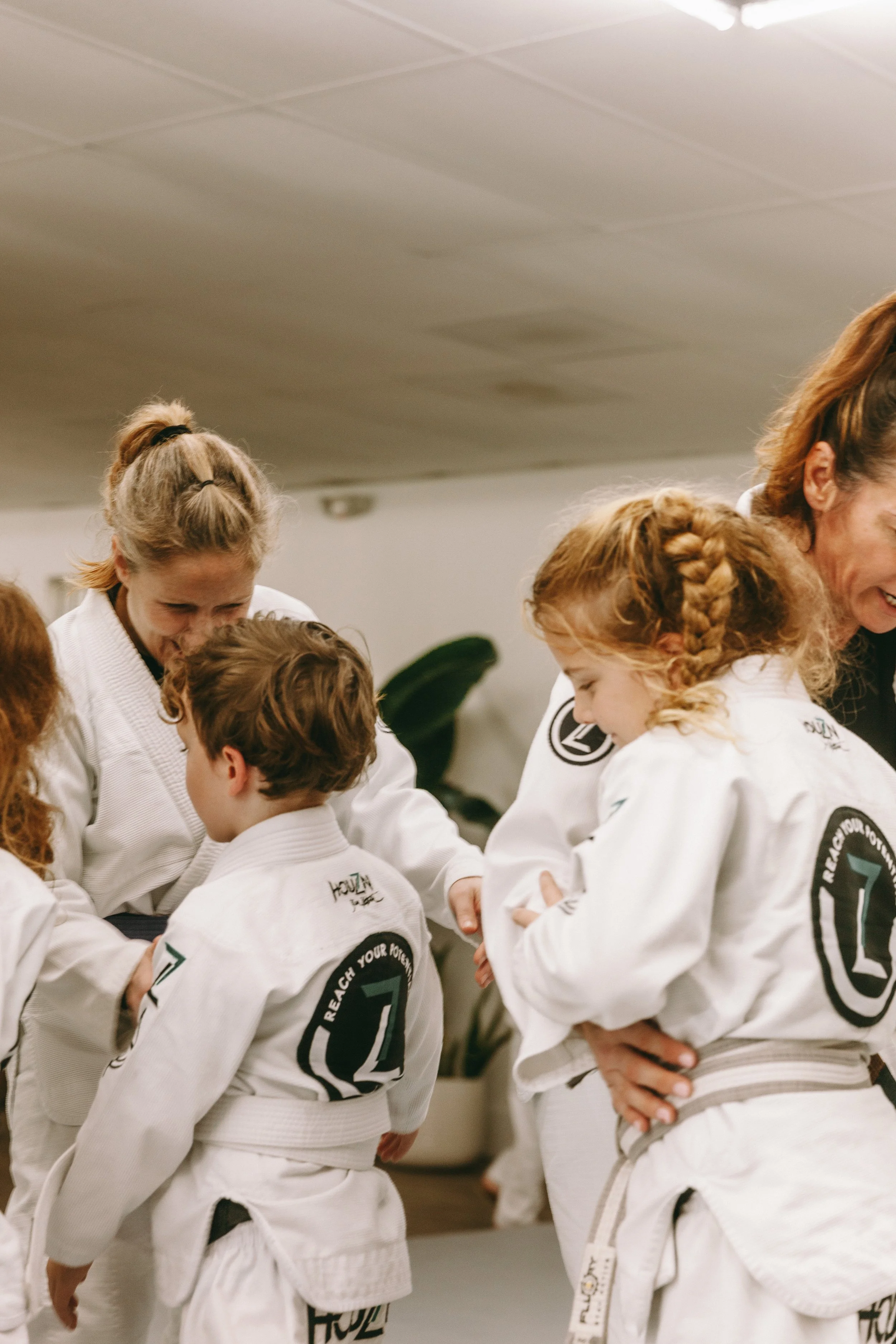 Kids Brazilian Jiu Jitsu class with coaches guiding young students on the mats at Houzn Jiu Jitsu Academy in Mount Pleasant, South Carolina.