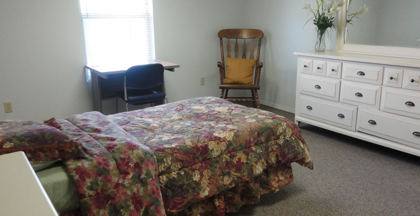 room with bed , chair and dresser