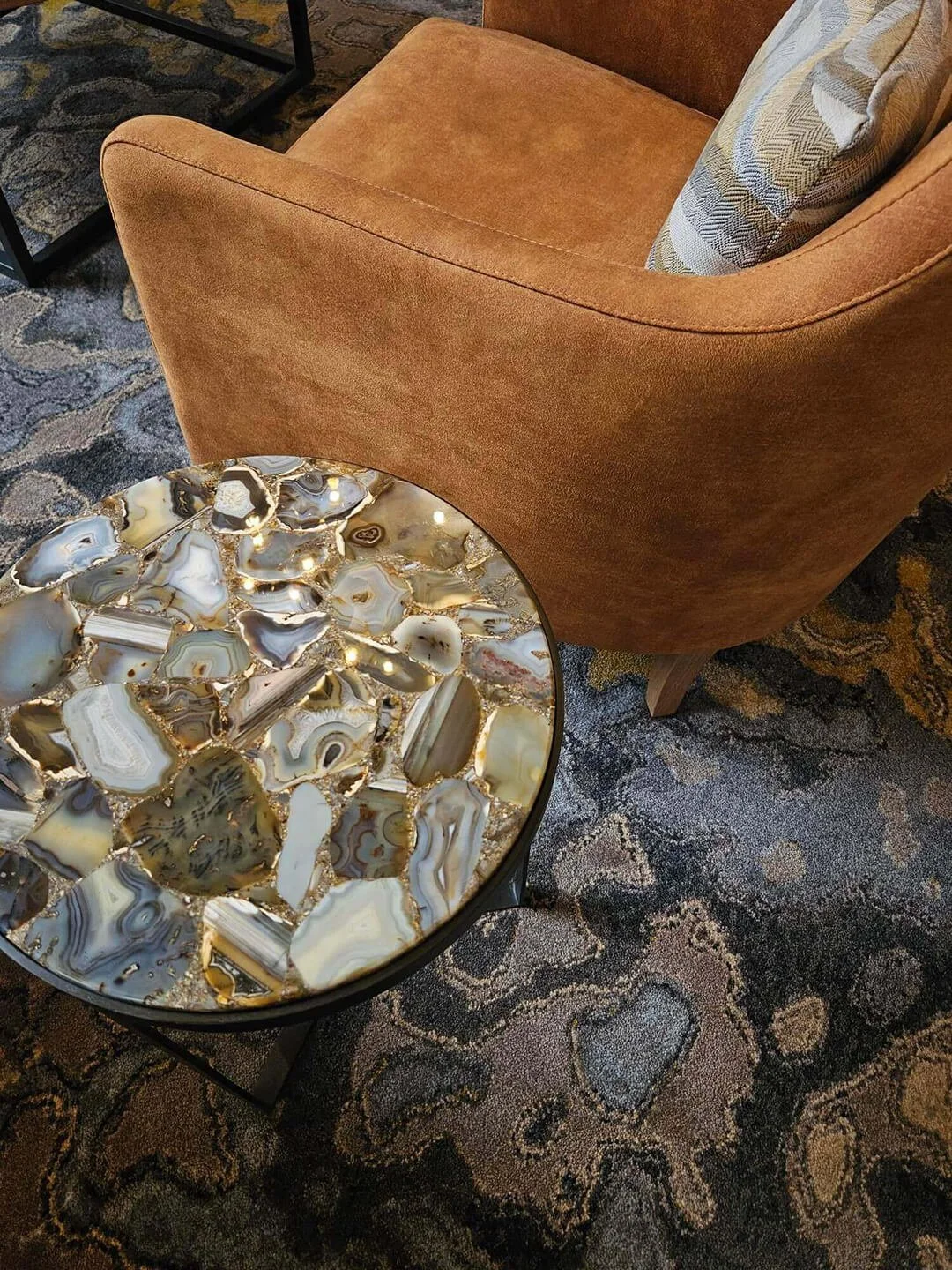 Organic stone coffee table styling with warm, earthy tones and relaxed living aesthetic.
