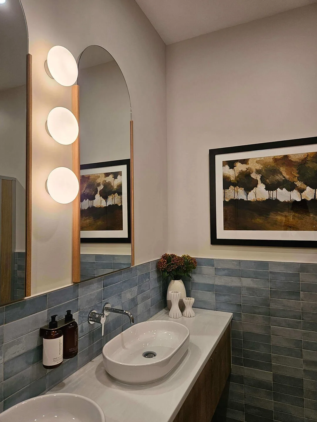Modern vanity space with warm lighting and natural finishes for a spa-like atmosphere.
