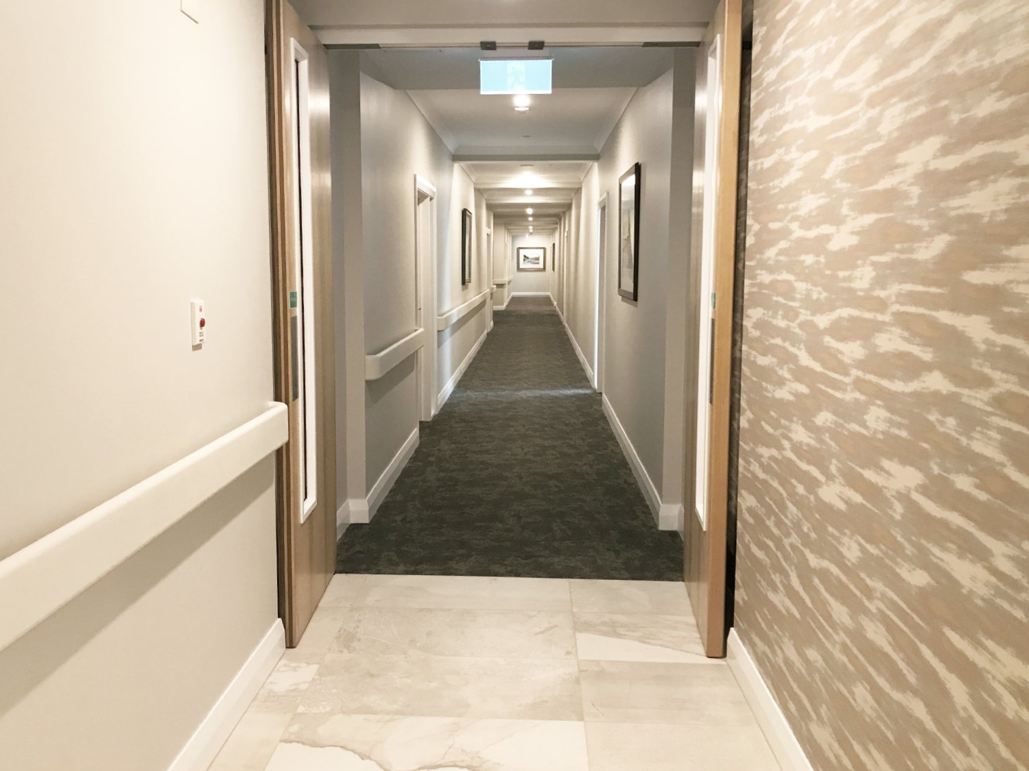 Chic healthcare interior design of hallway with pattern wallpaper, New Zealand.