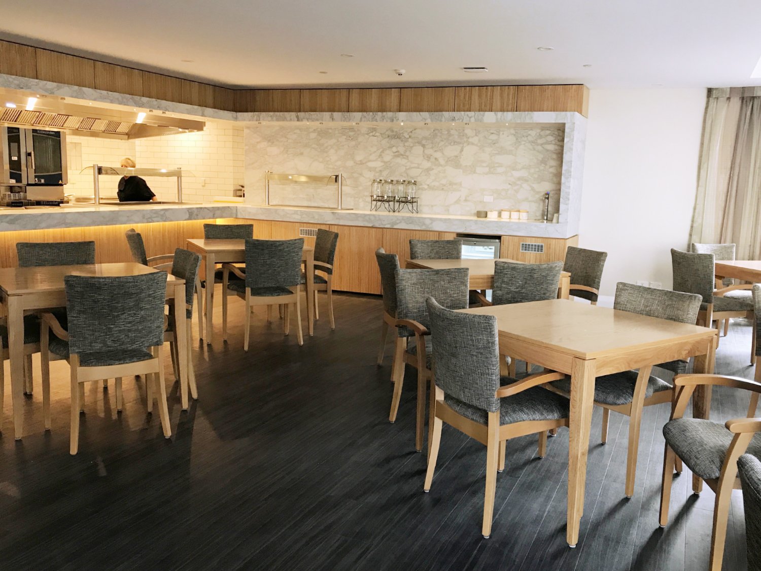 Chic healthcare dining room interior with statement hardwood floor, New Zealand.