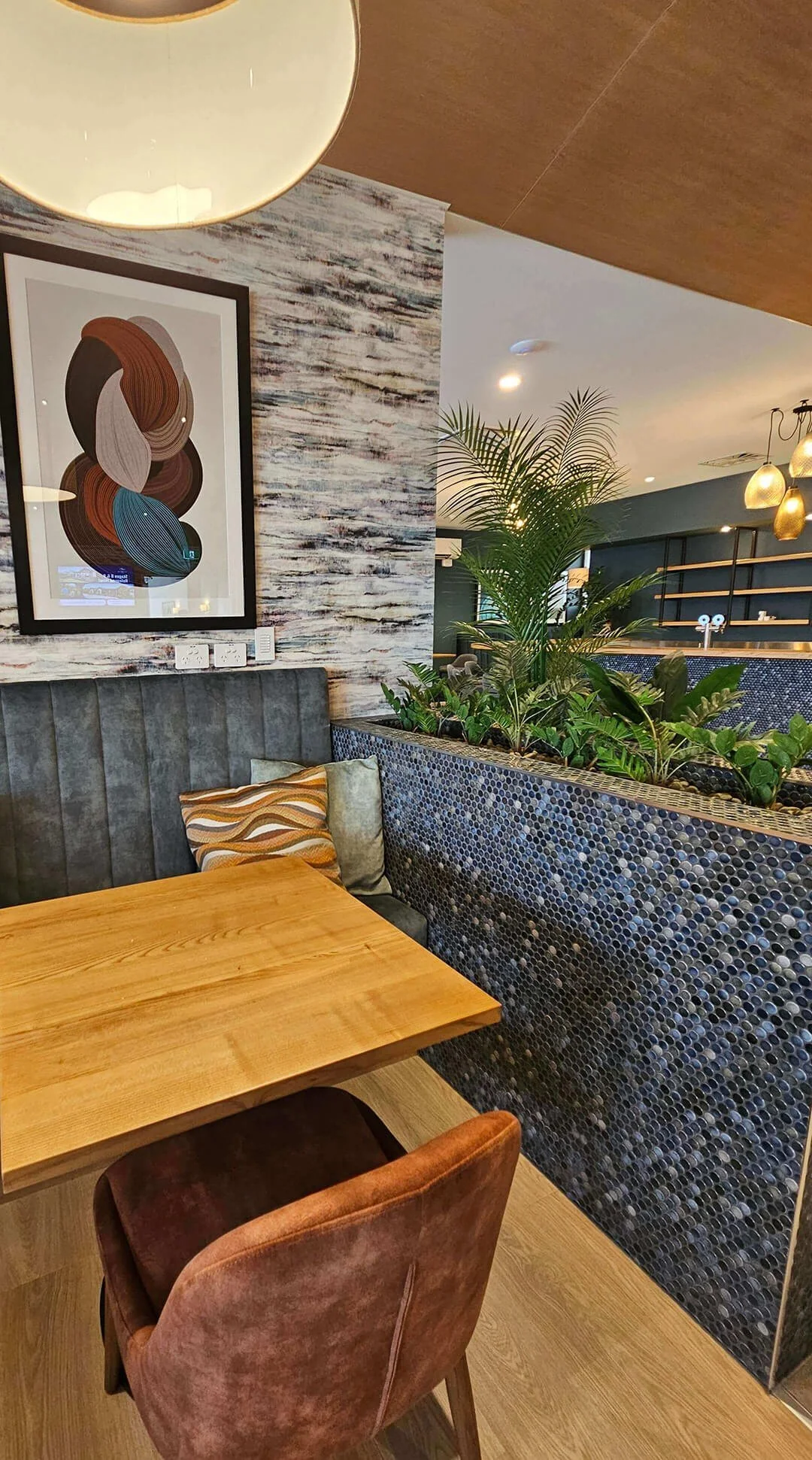 Integrated indoor planting and stone textures supporting wellness-focused interior design.