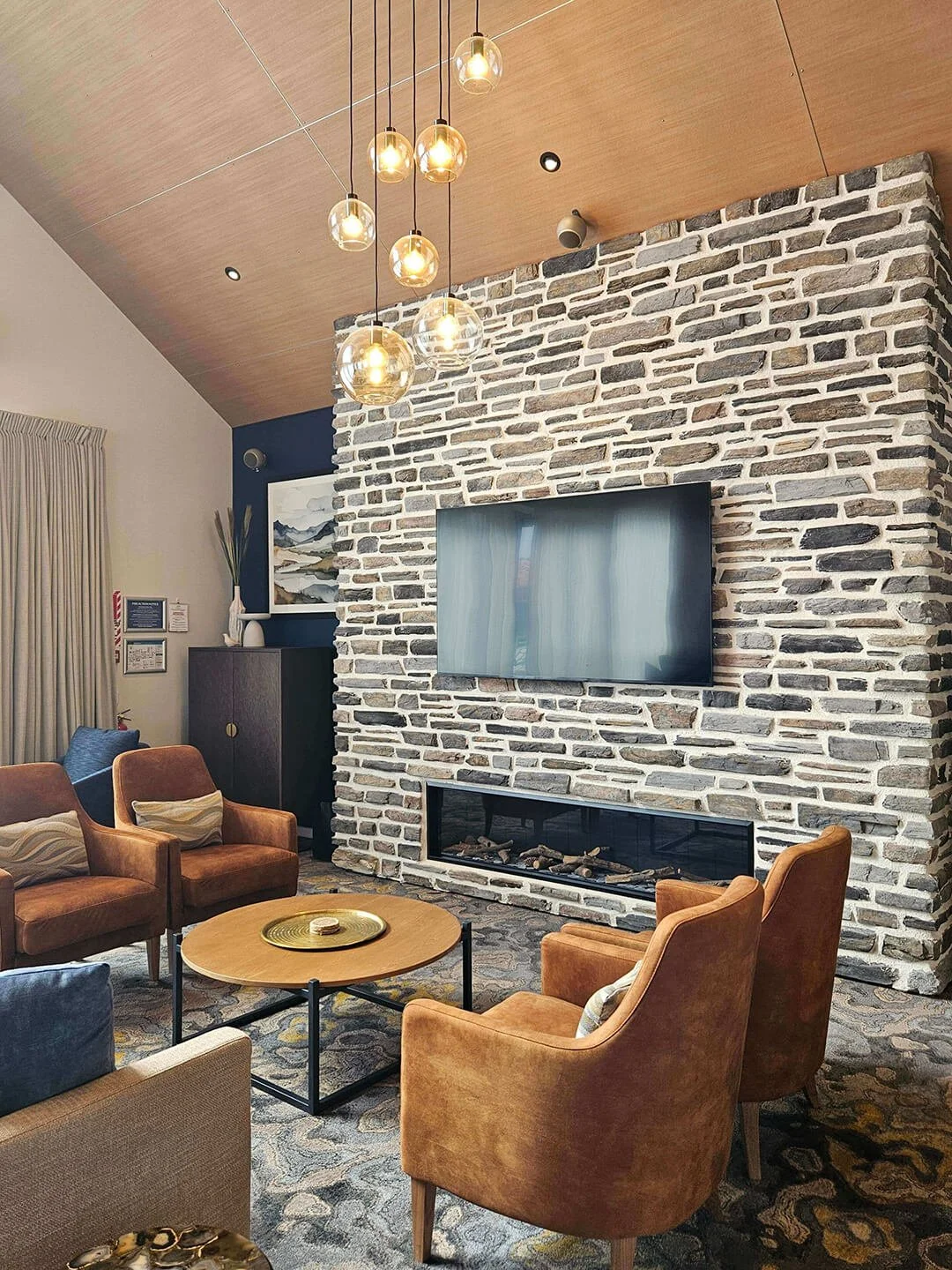 Inviting lounge design with earthy tones, stone textures, and relaxed, wellness-inspired styling.