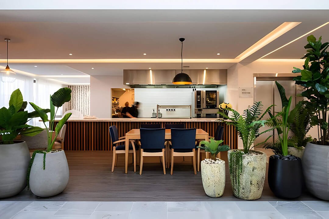 Modern Open-Plan Kitchen and Dining Area - Auckland Interior Design. A stylish open-plan kitchen and dining area featuring sleek cabinetry, pendant lighting, and a harmonious blend of natural materials, demonstrating contemporary interior design in A