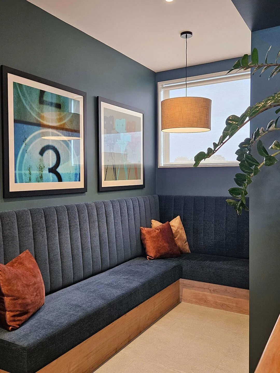 Custom booth seating with layered cushions, creating a cosy and intimate dining nook.