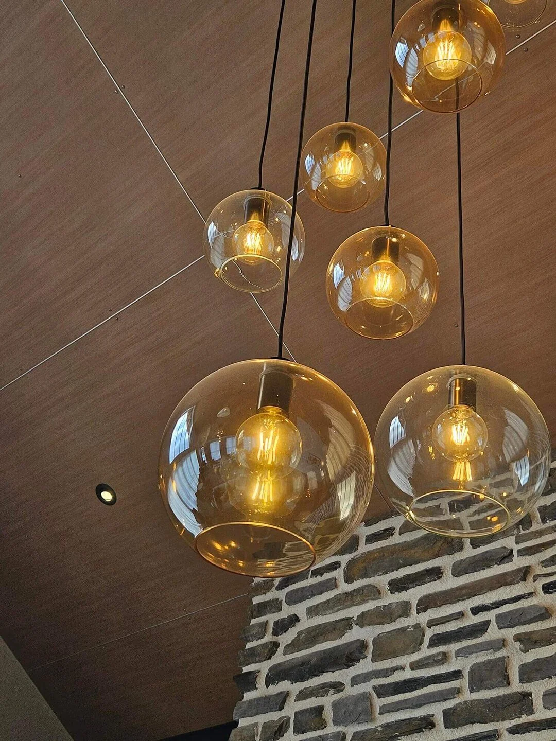 Sculptural pendant lighting installation adding warmth and ambience to a contemporary interior.