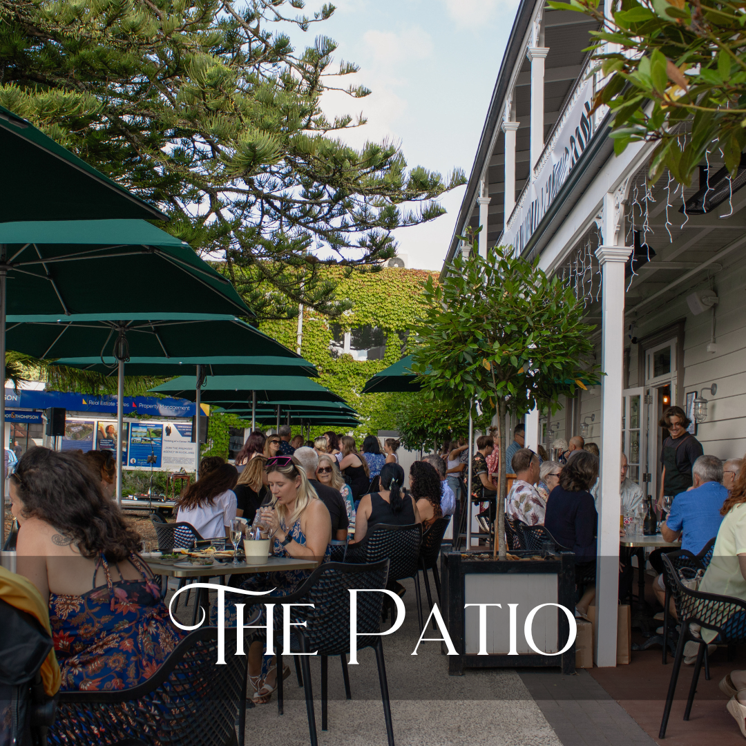 The patio with full tables of diners on a sunny afternoon.