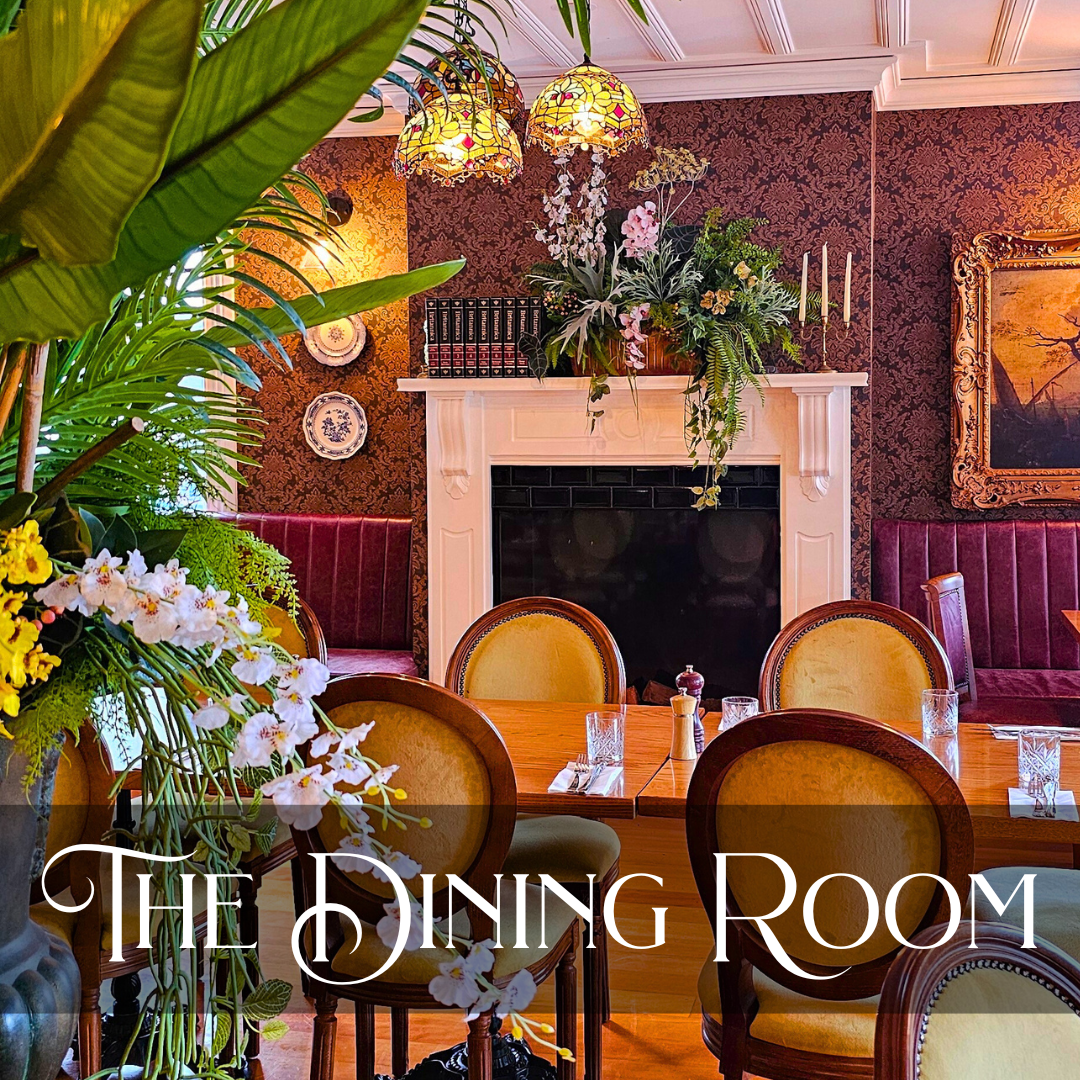 View of the Dining Room at The Warkworth Hotel with greenery,  vintage decor and plush velvet seats.