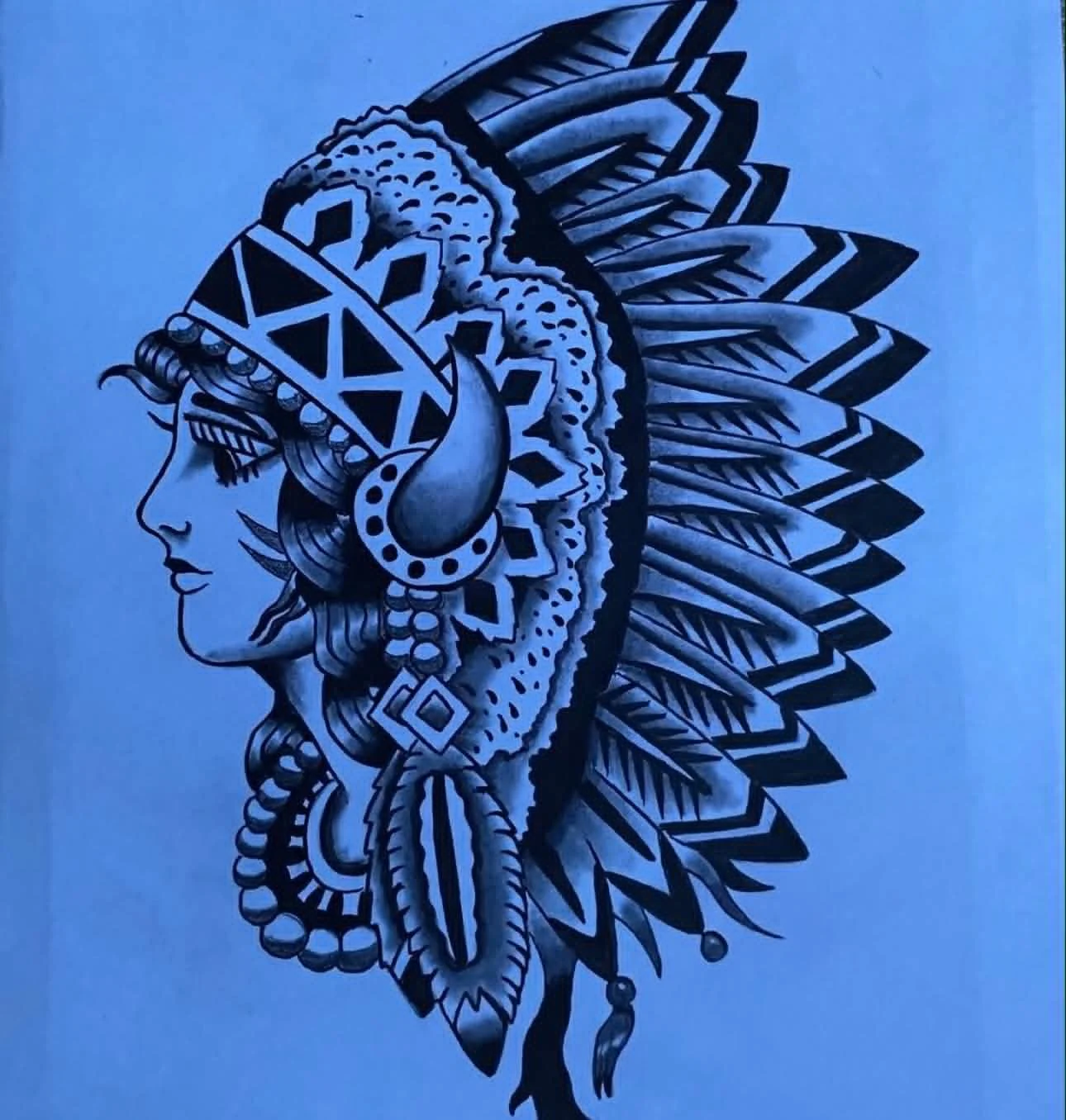 Black and white illustration of a Native American woman in profile, wearing a feathered headdress and traditional jewelry.