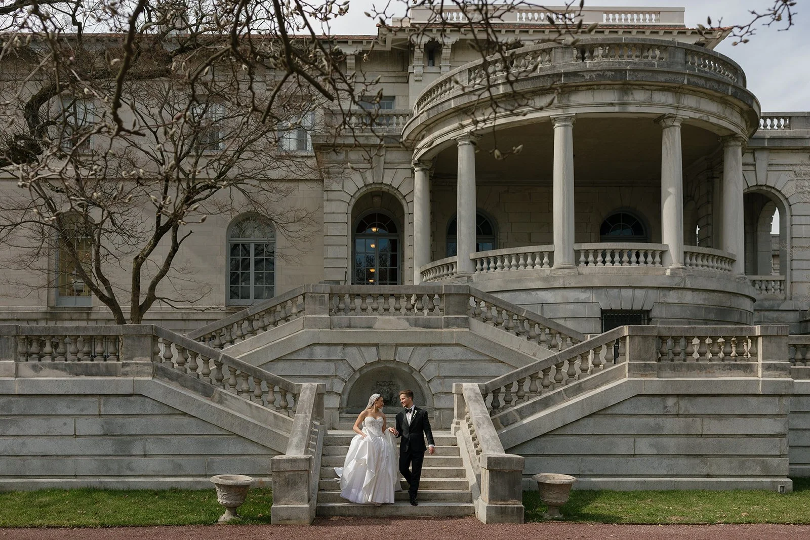 Candid portrait of elegant couple walking hand in hand through a European-inspired Elkins Estate.