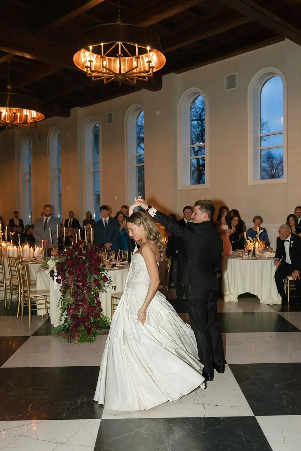 Bride and groom sharing a joyful first dance inside an elegant estate wedding venue in Elkins Park, Pennsylvania.
