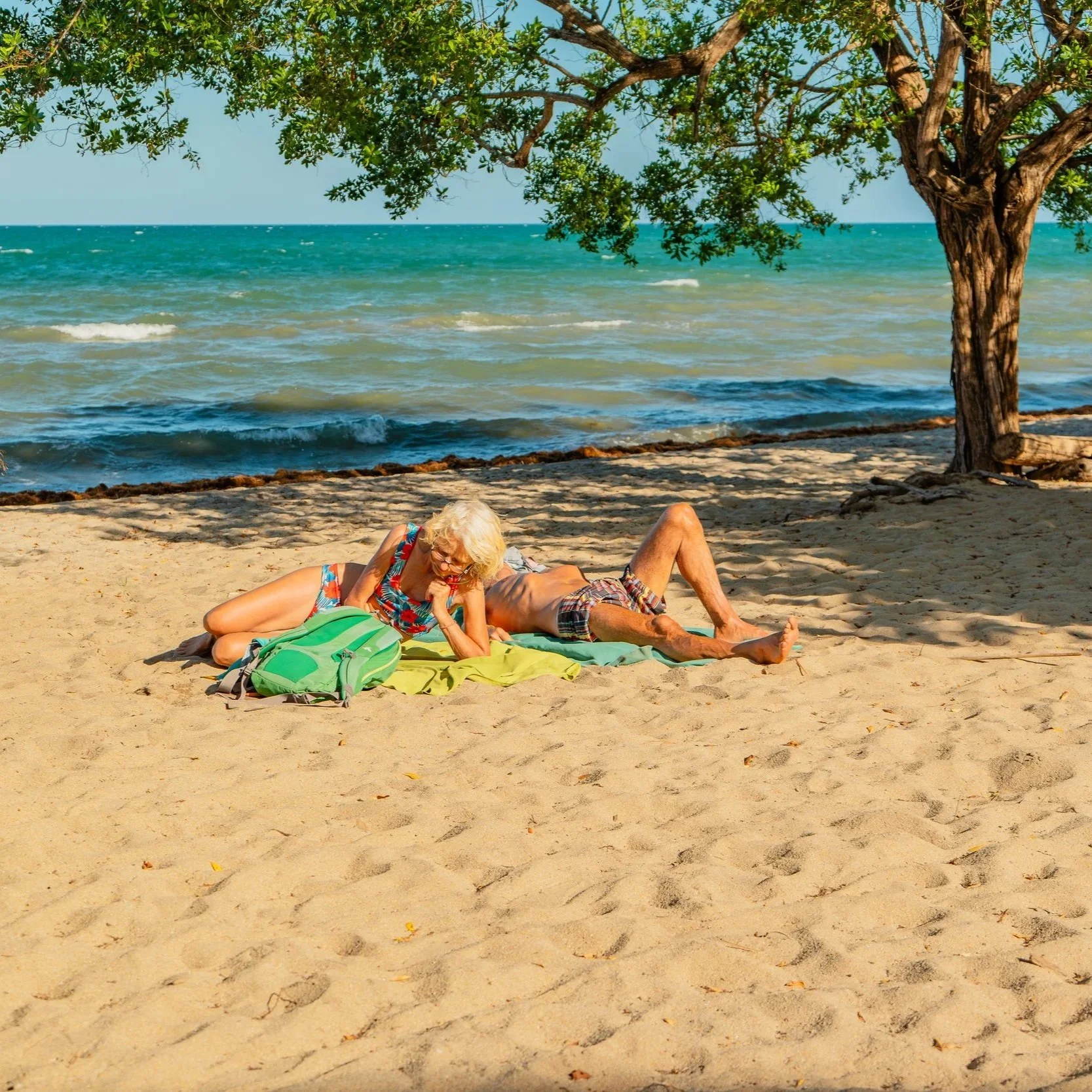 Beams of sunlight pierce the darkness of Caves Branch’s ceremonial cave, cascading through the sinkhole opening and lighting the interior in a dramatic glow.