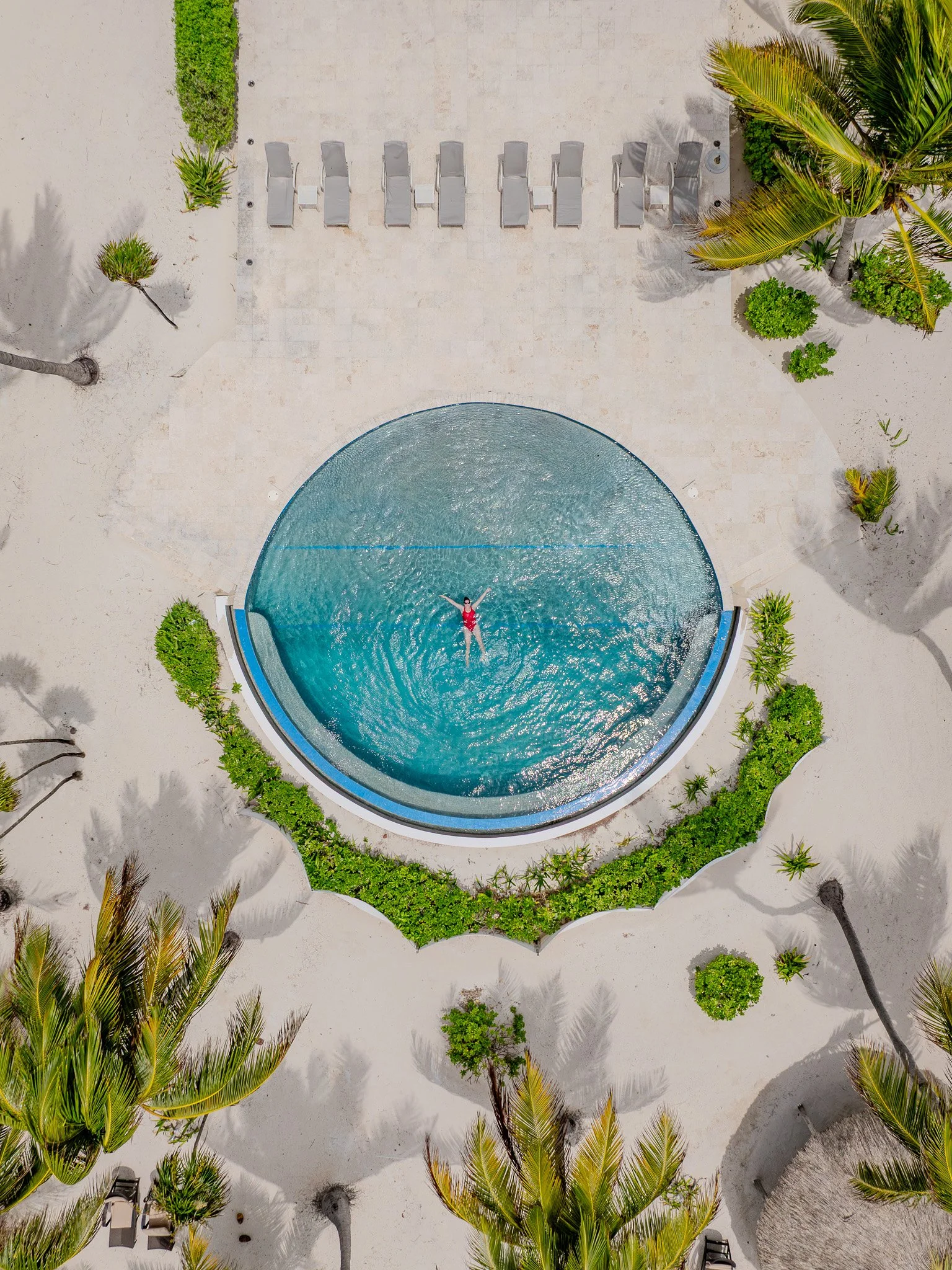 A guest standing in the open doorway of a private balcony at San Ignacio Resort Hotel, overlooking the dense tropical jungle canopy of the Macal River valley.