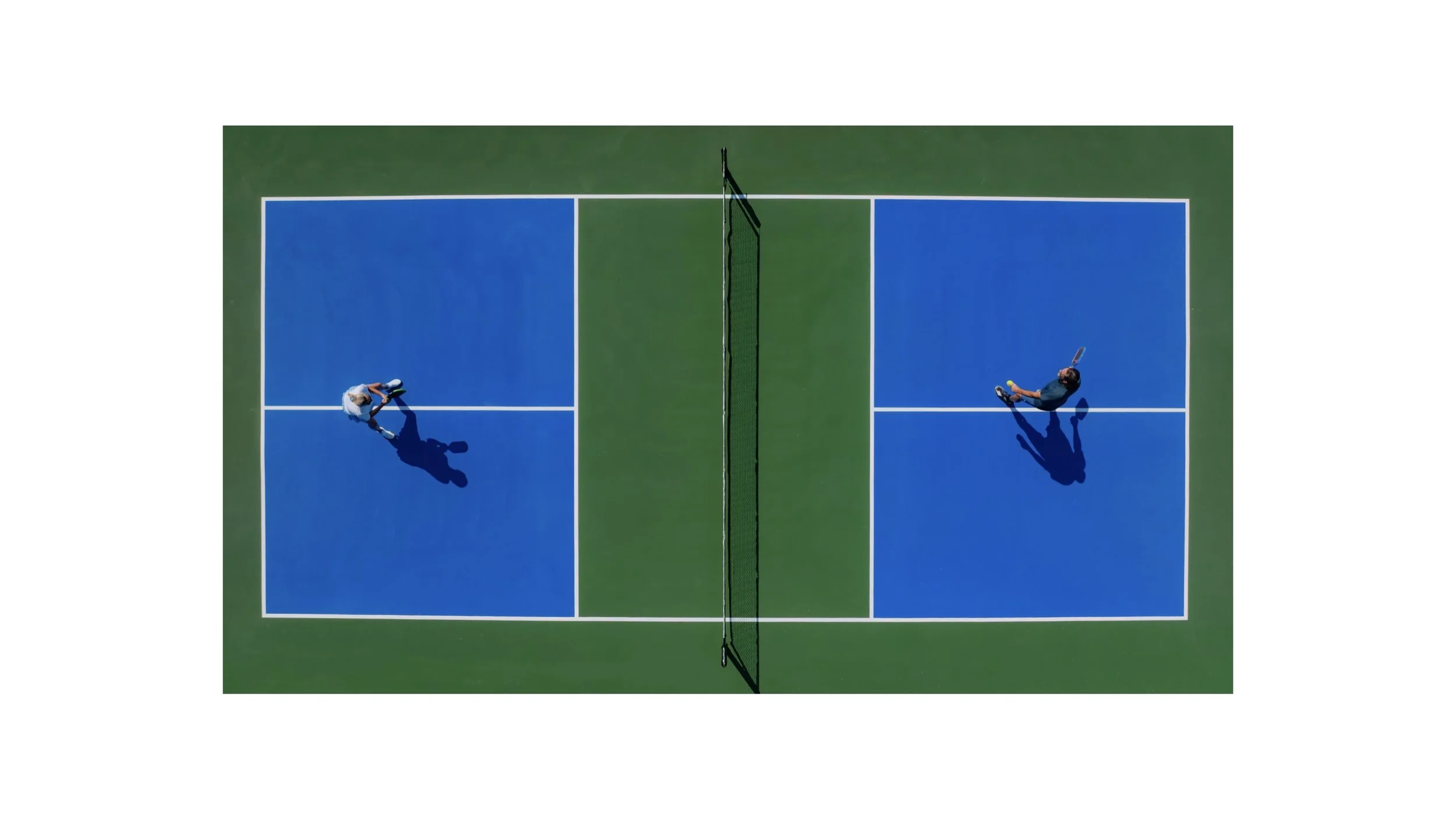 Symmetrical overhead view of two people playing on the vibrant green and blue pickleball courts at Naia Resort and Spa