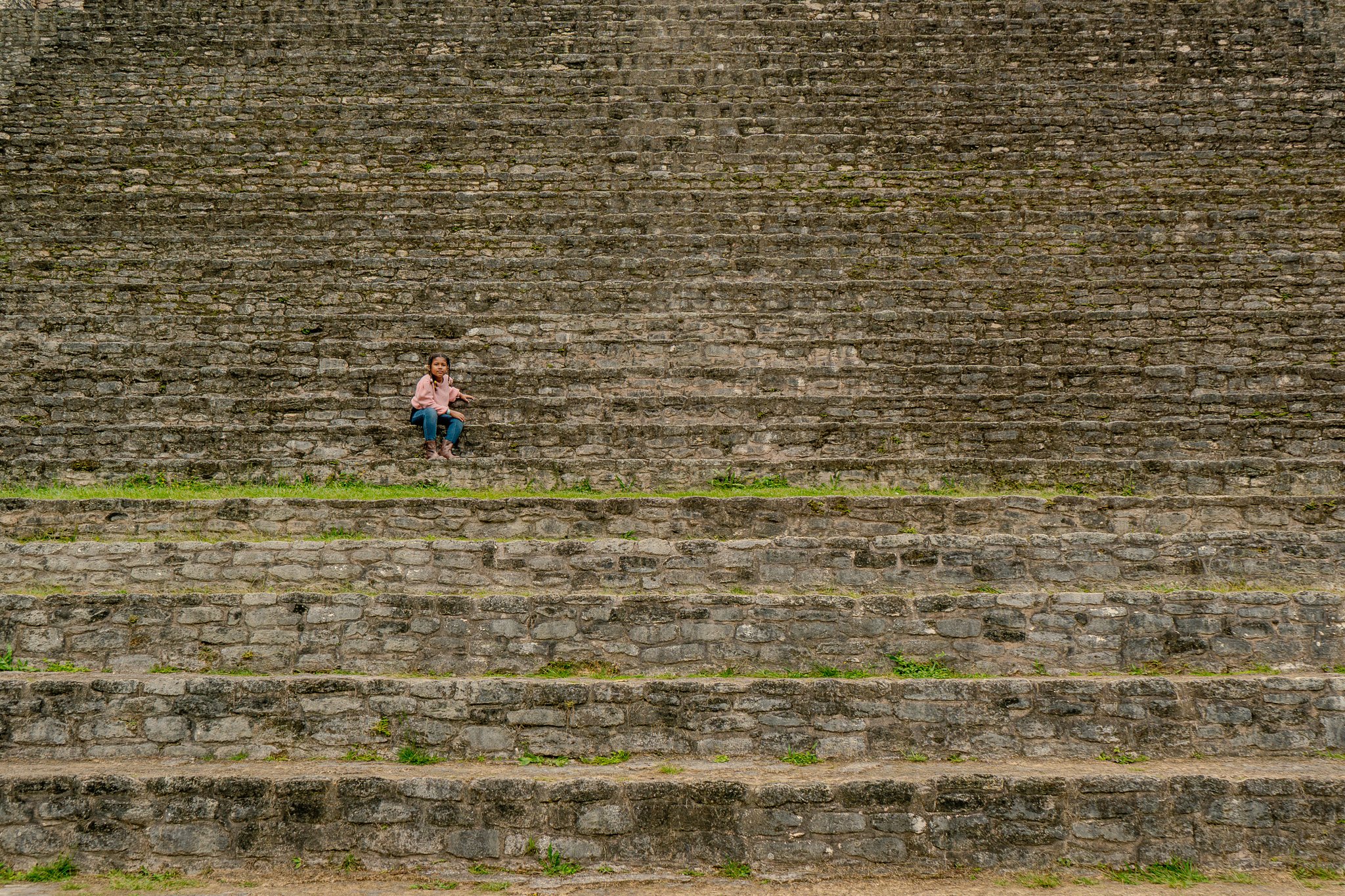 Guided through the river cave, two women on tubes are awestruck as their lamps illuminate a giant stalactite chandelier above them.
