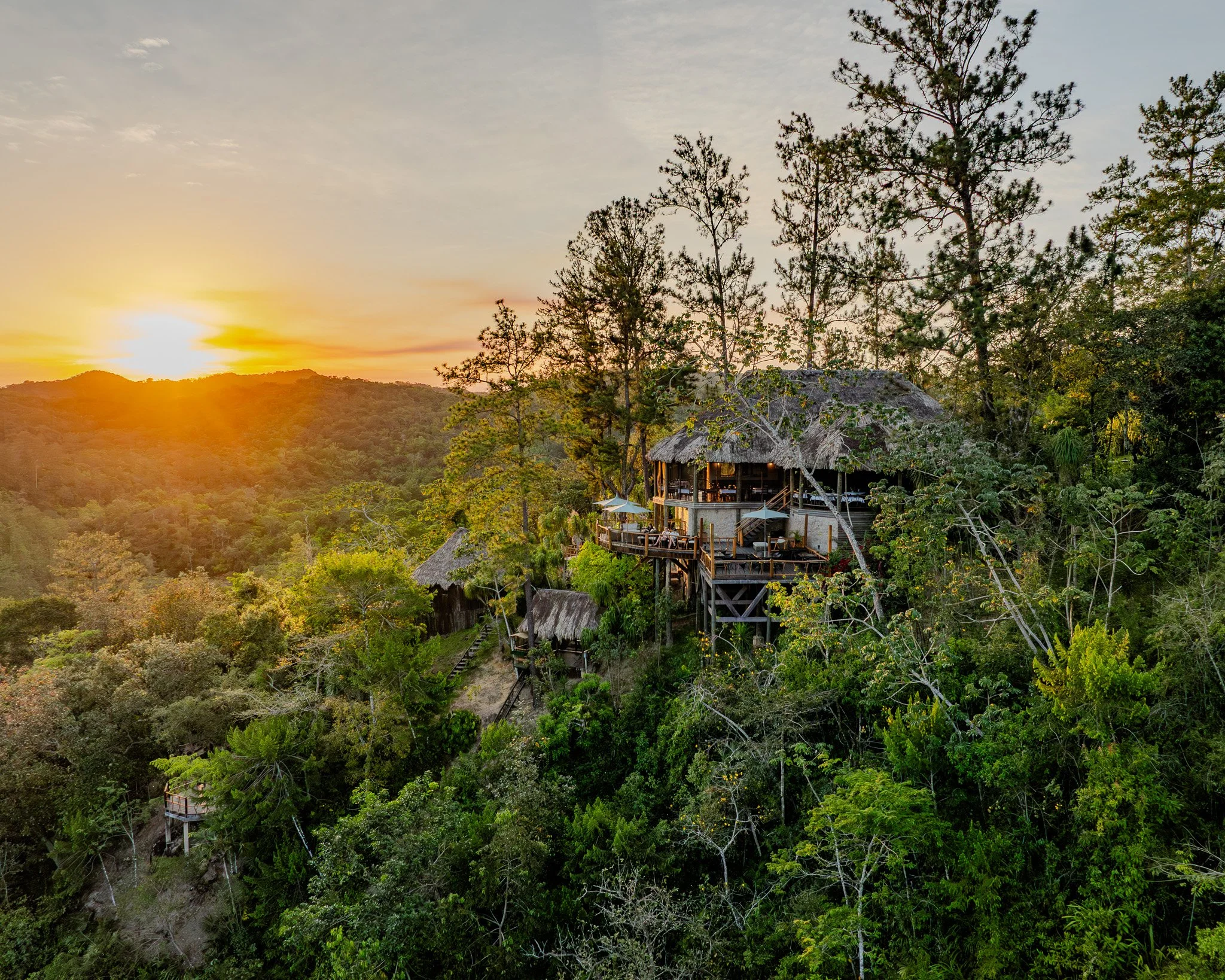 In a hidden corner of the cave, a guide and explorer uncover an ancient Maya shoe pot, a glimpse into history amidst the darkness.