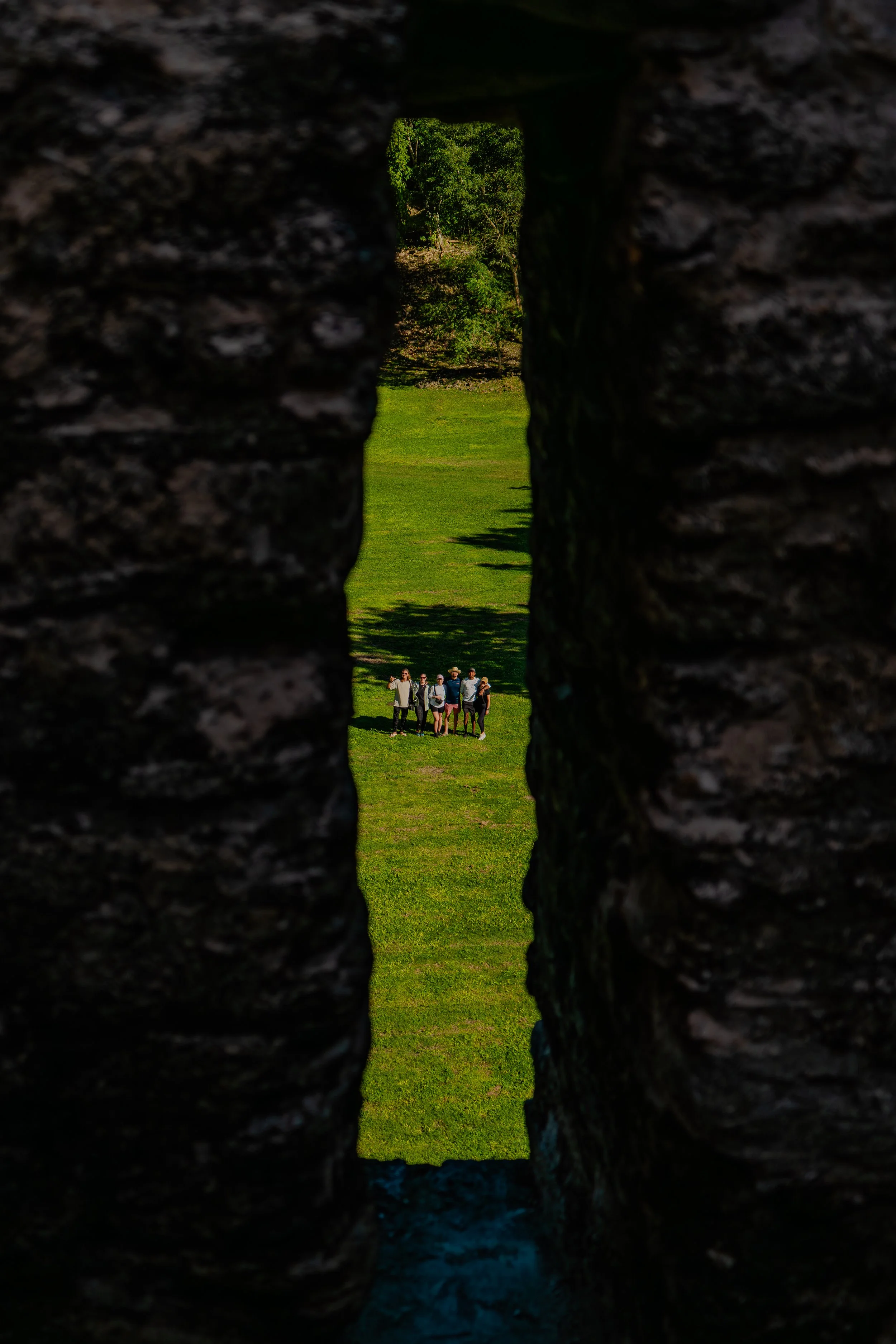Two explorers wander through a cave completely engulfed by ancient, intricate rock formations.