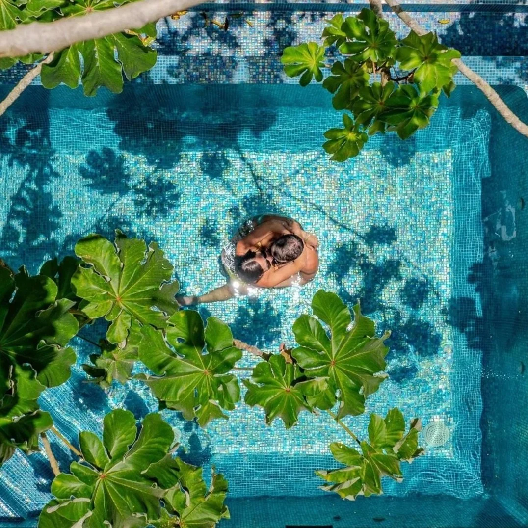 A guest standing in the open doorway of a private balcony at San Ignacio Resort Hotel, overlooking the dense tropical jungle canopy of the Macal River valley.