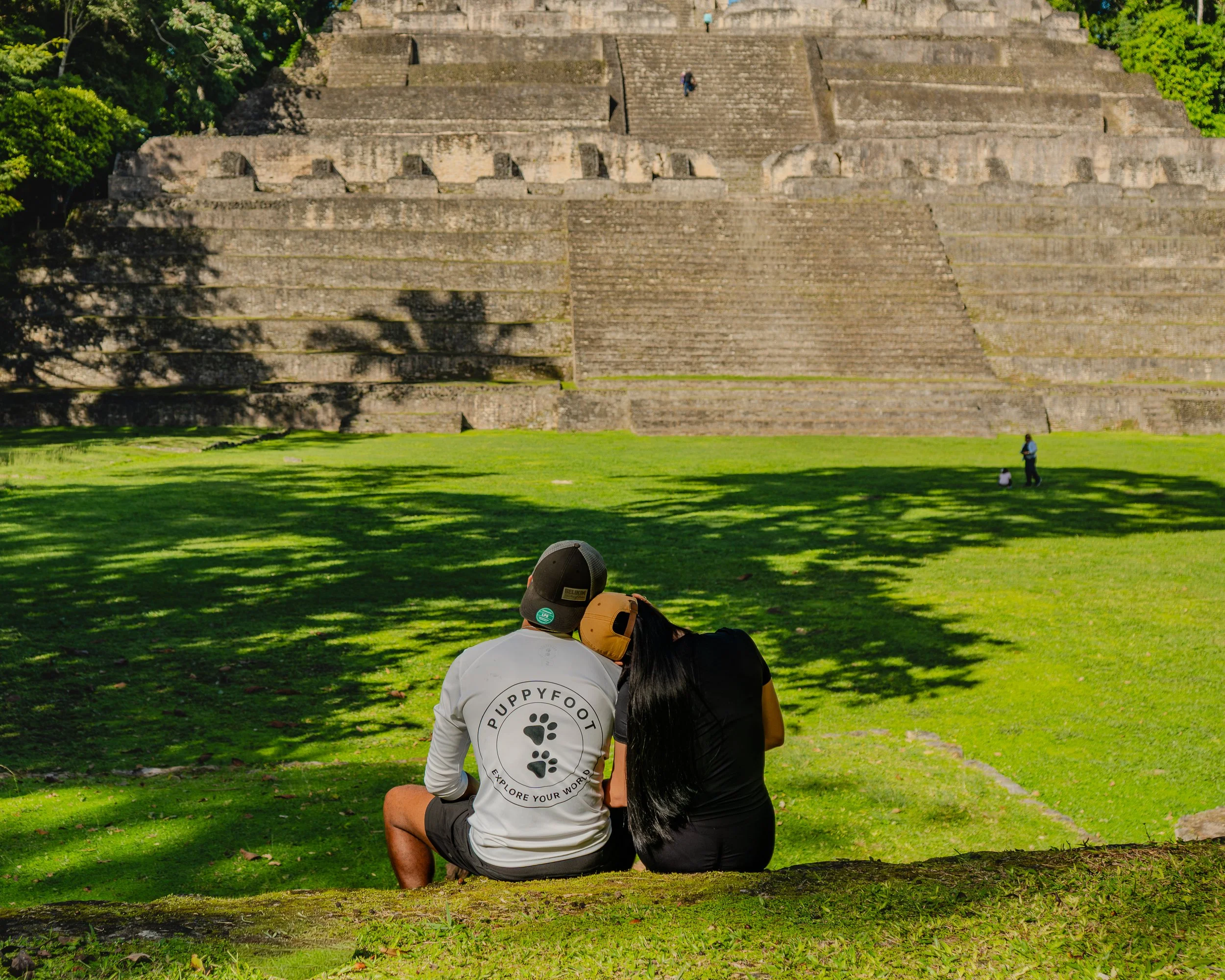 In a hidden corner of the cave, a guide and explorer uncover an ancient Maya shoe pot, a glimpse into history amidst the darkness.