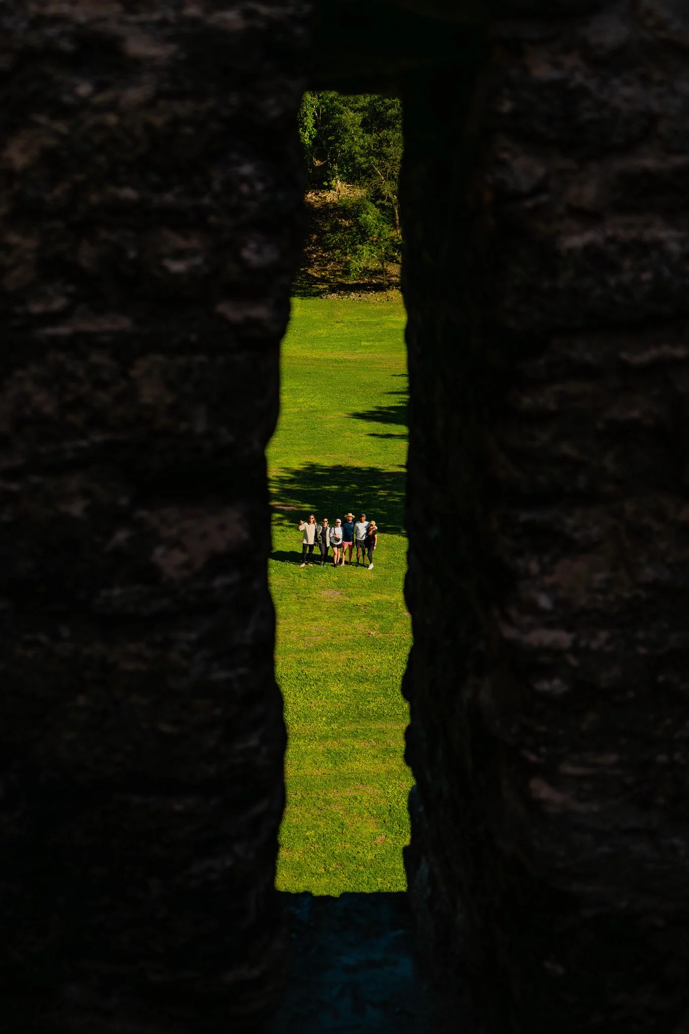 Two explorers wander through a cave completely engulfed by ancient, intricate rock formations.