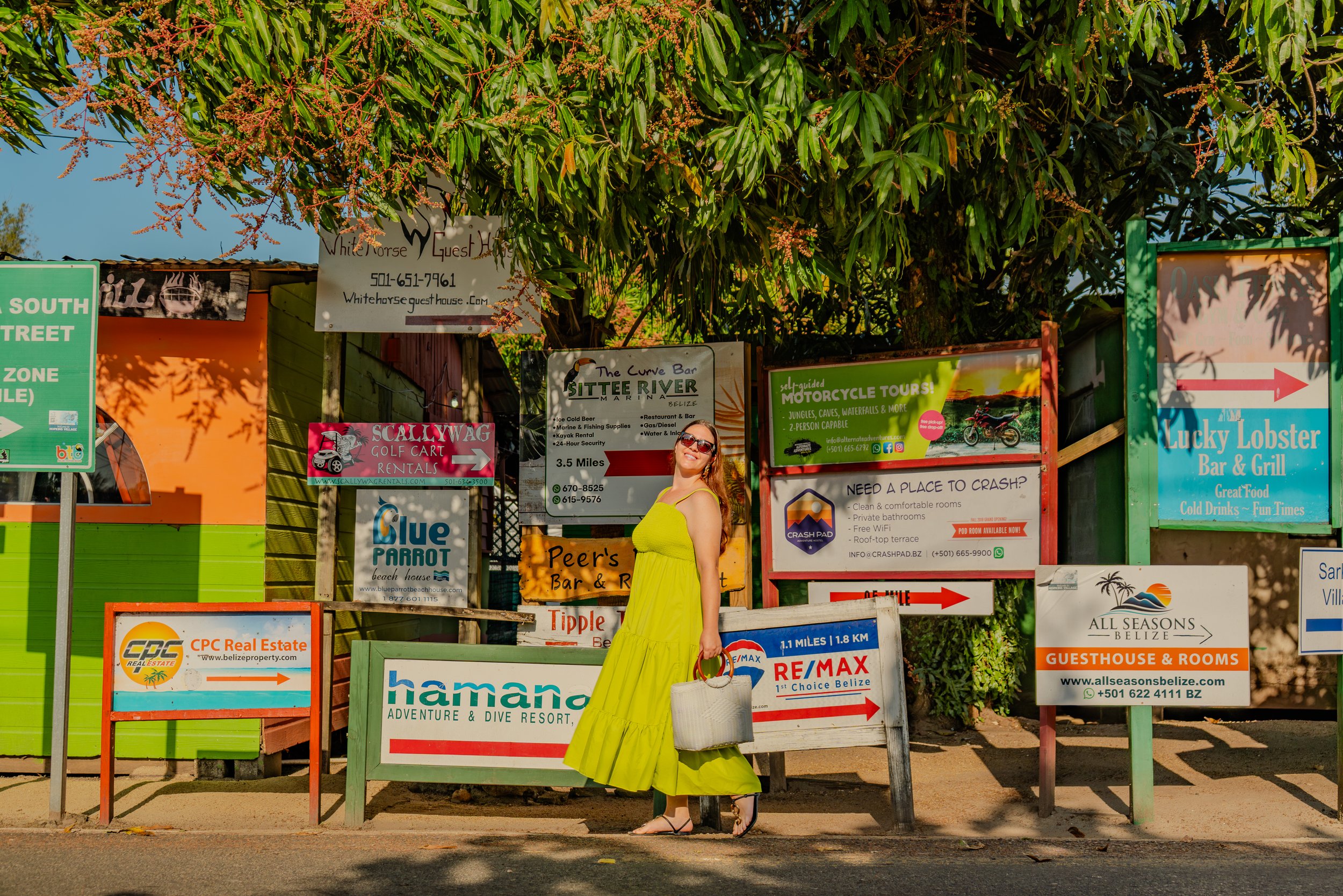 Under beautiful lighting, three women savor a buffet lunch atop an inverted kayak, set against the river’s edge with sweeping mountains and the river stretching behind them.