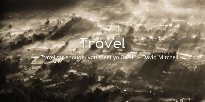 Sun's rays shining over a landscape with trees and buildings, with the word 'Travel' and a quote about travel by David Mitchell.