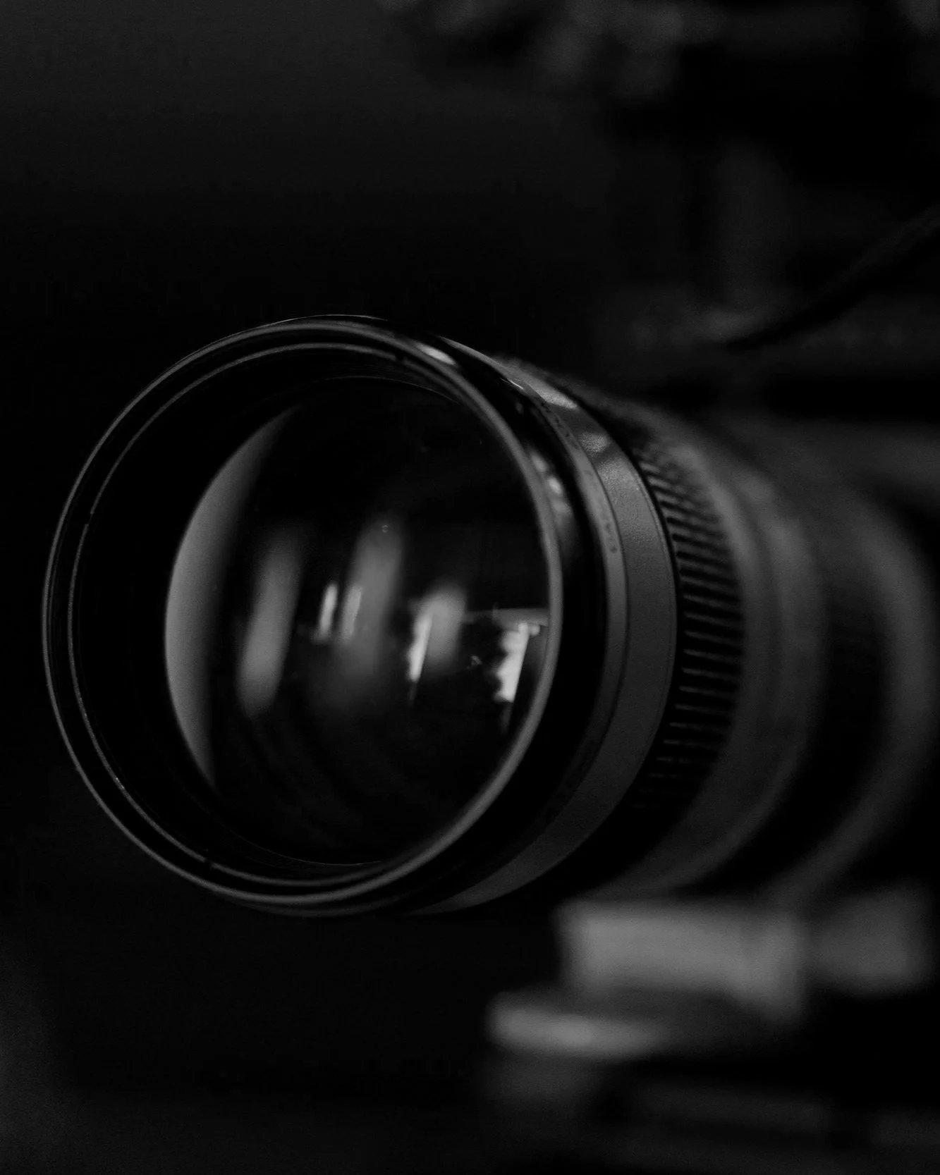 Close-up of a camera lens on a black background.