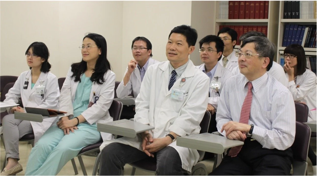 Medical professionals attending a conference or meeting in a classroom or conference room setting.