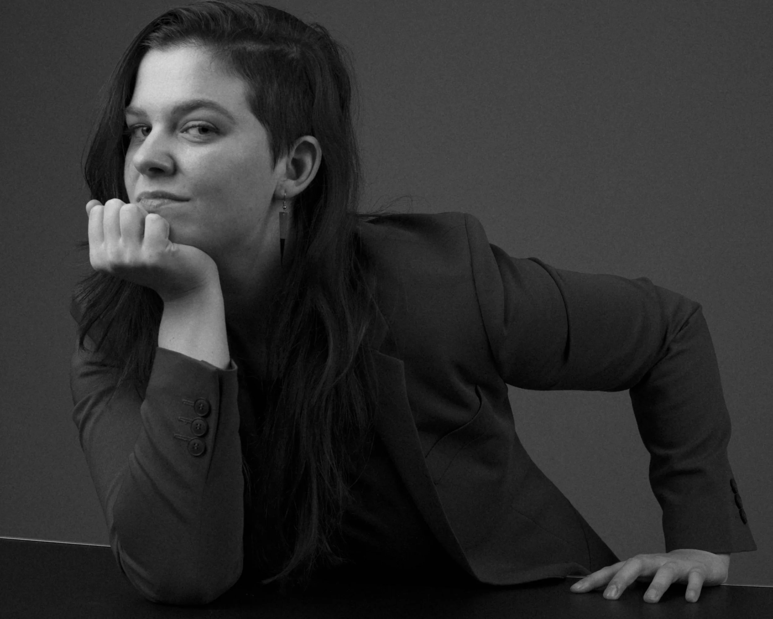 Maya leaning on a desk