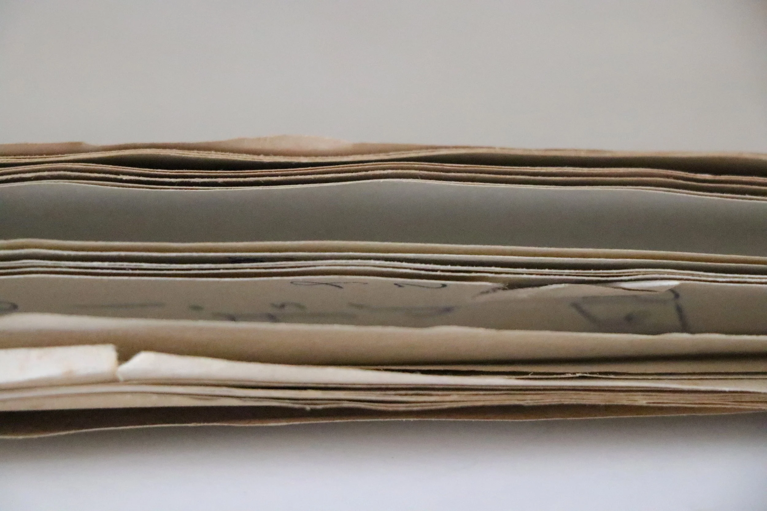 A close-up view of a stack of music sheets and papers with handwritten notes