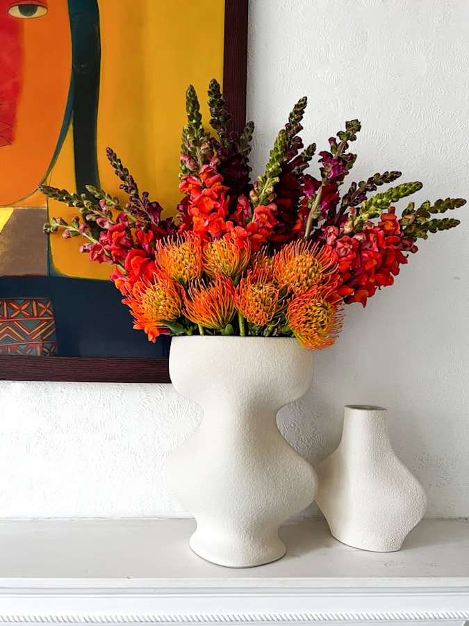 Vibrant floral arrangement in white vase