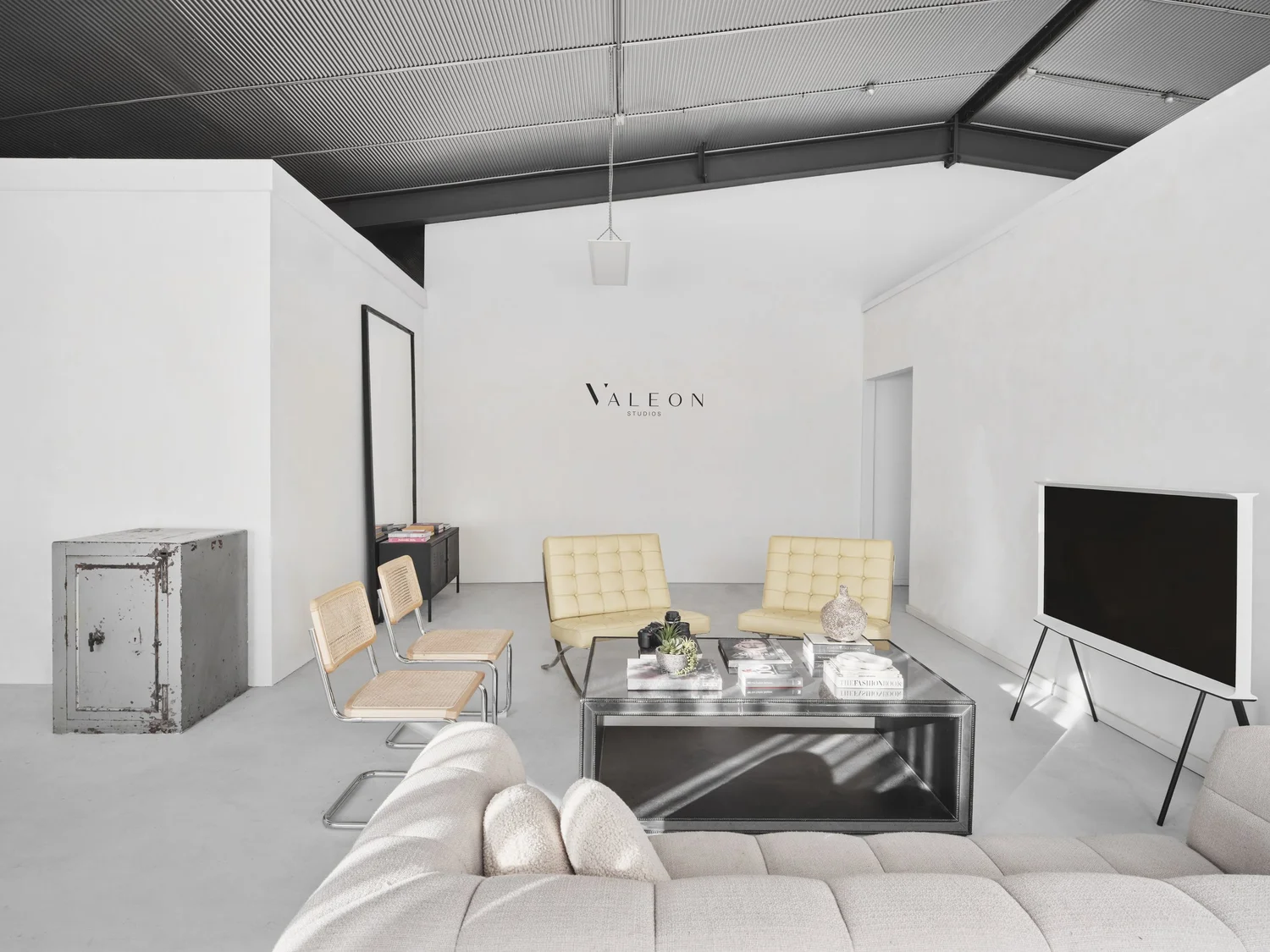 Wide view of adjoining white shooting bays at Valeon Studios, with lighting equipment and industrial ceiling.