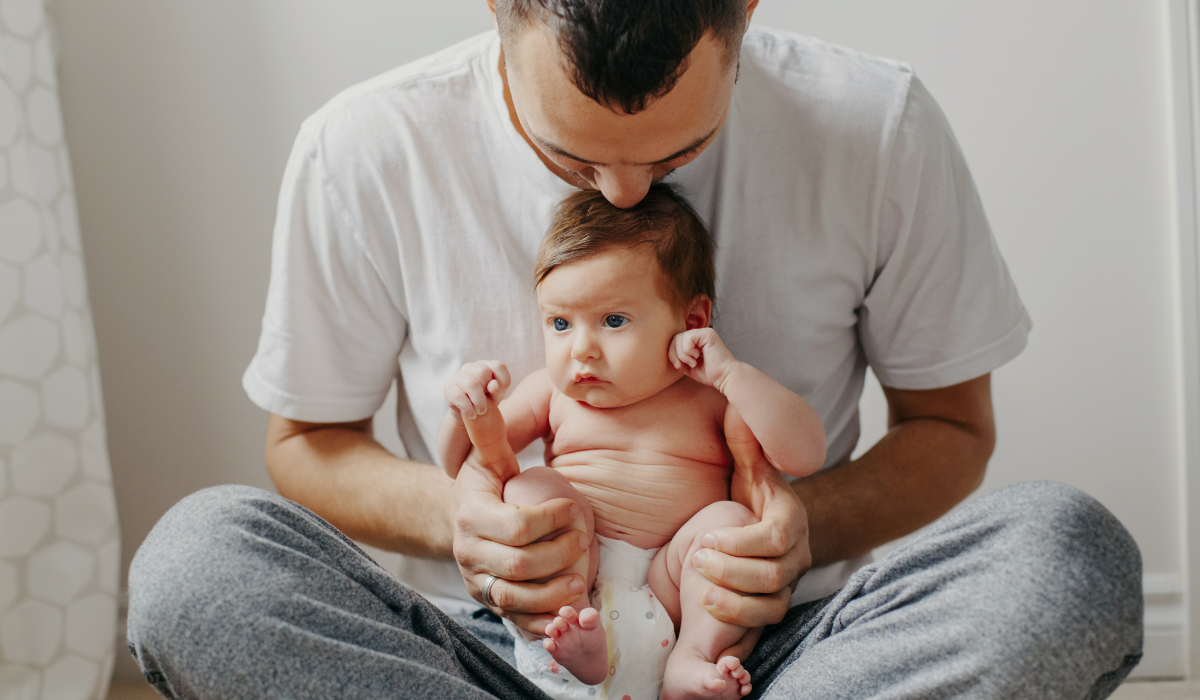 father with baby navigating fatherhood with therapy for new dads calgary