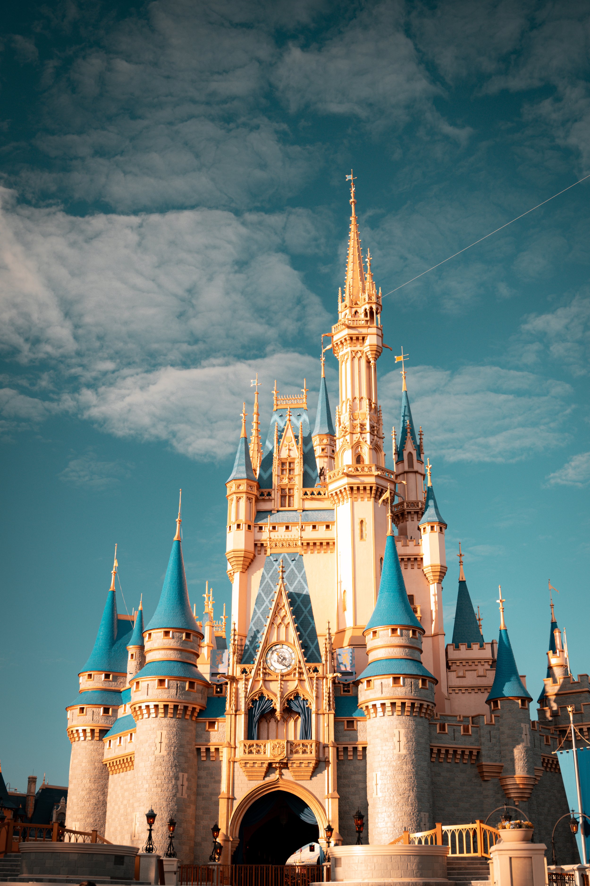 Sleeping Beauty Castle at Disneyland with blue roof spires and a cloudy sky