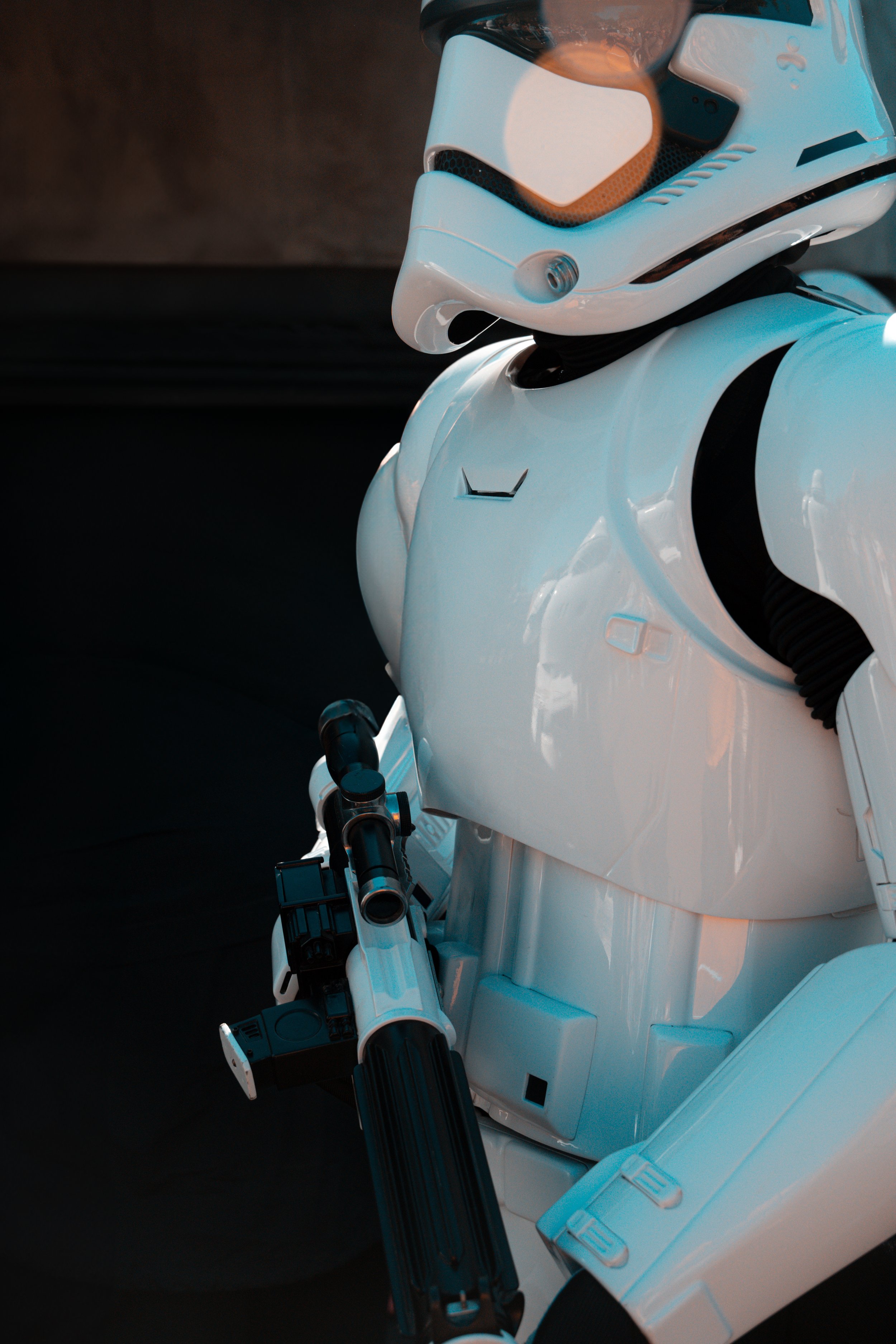 Close-up photo of a humanoid robot with a white exterior holding a black robotic arm.