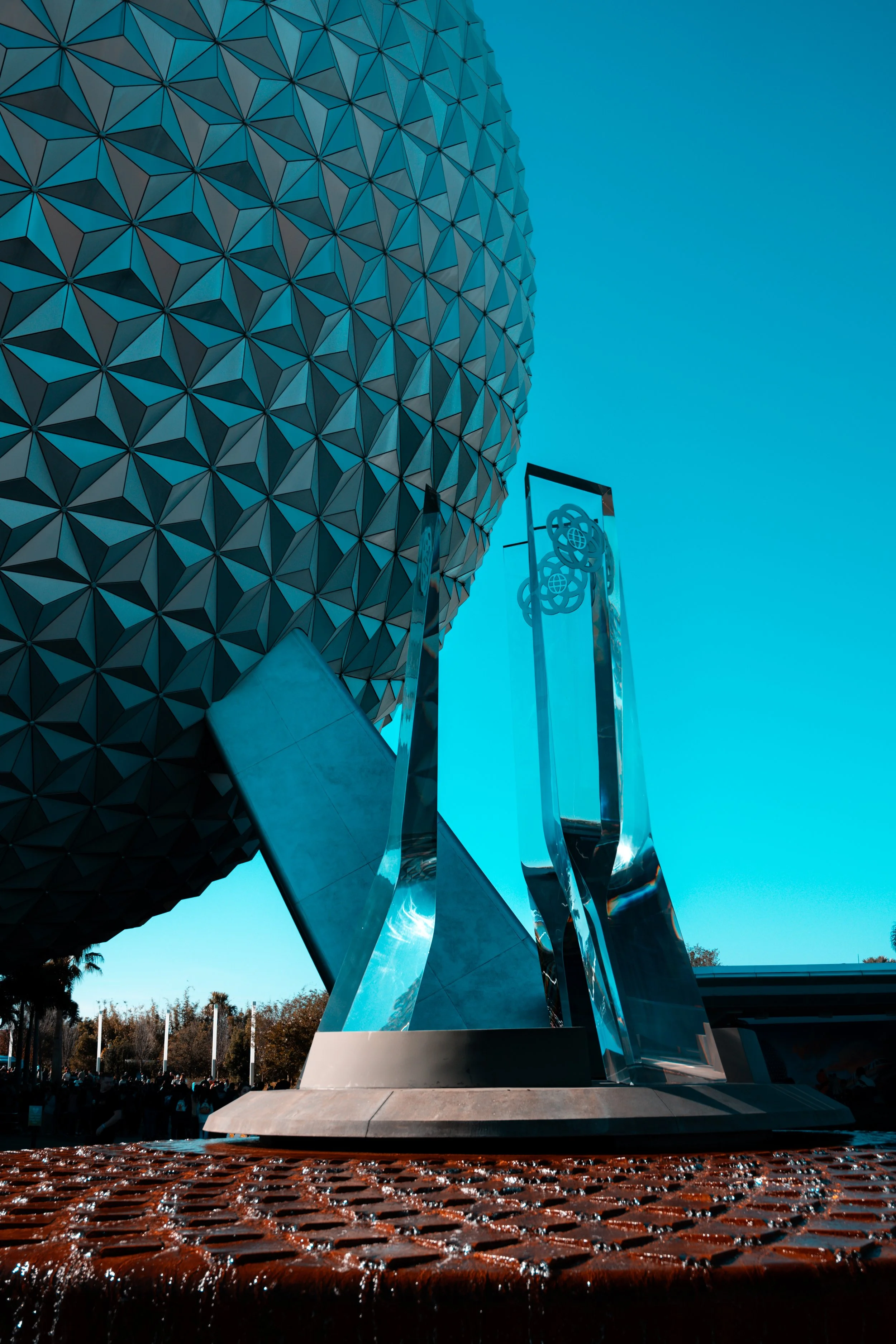 The Epcot ball with a cloudy blue sky in the background at Walt Disney World.