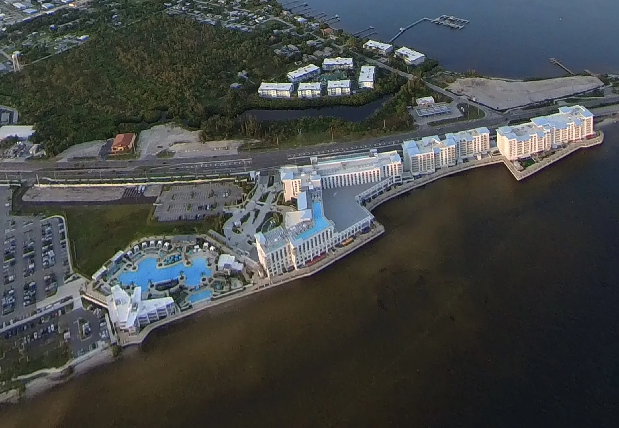 Aerial view of Sunseeker Resort hotel complex with a large swimming pool on a waterfront property.