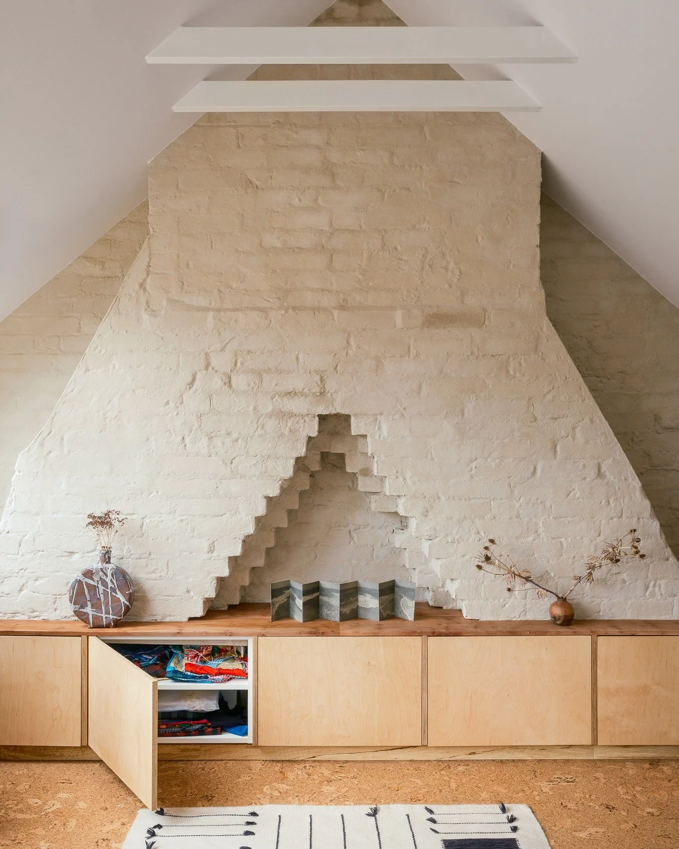 Sometimes, the most stunning details in a house are already there, waiting to be noticed. At this Warner House in Walthamstow, a limewash over the stepped brickwork of the chimney reveals the building's hidden textures and history, and meets the warm