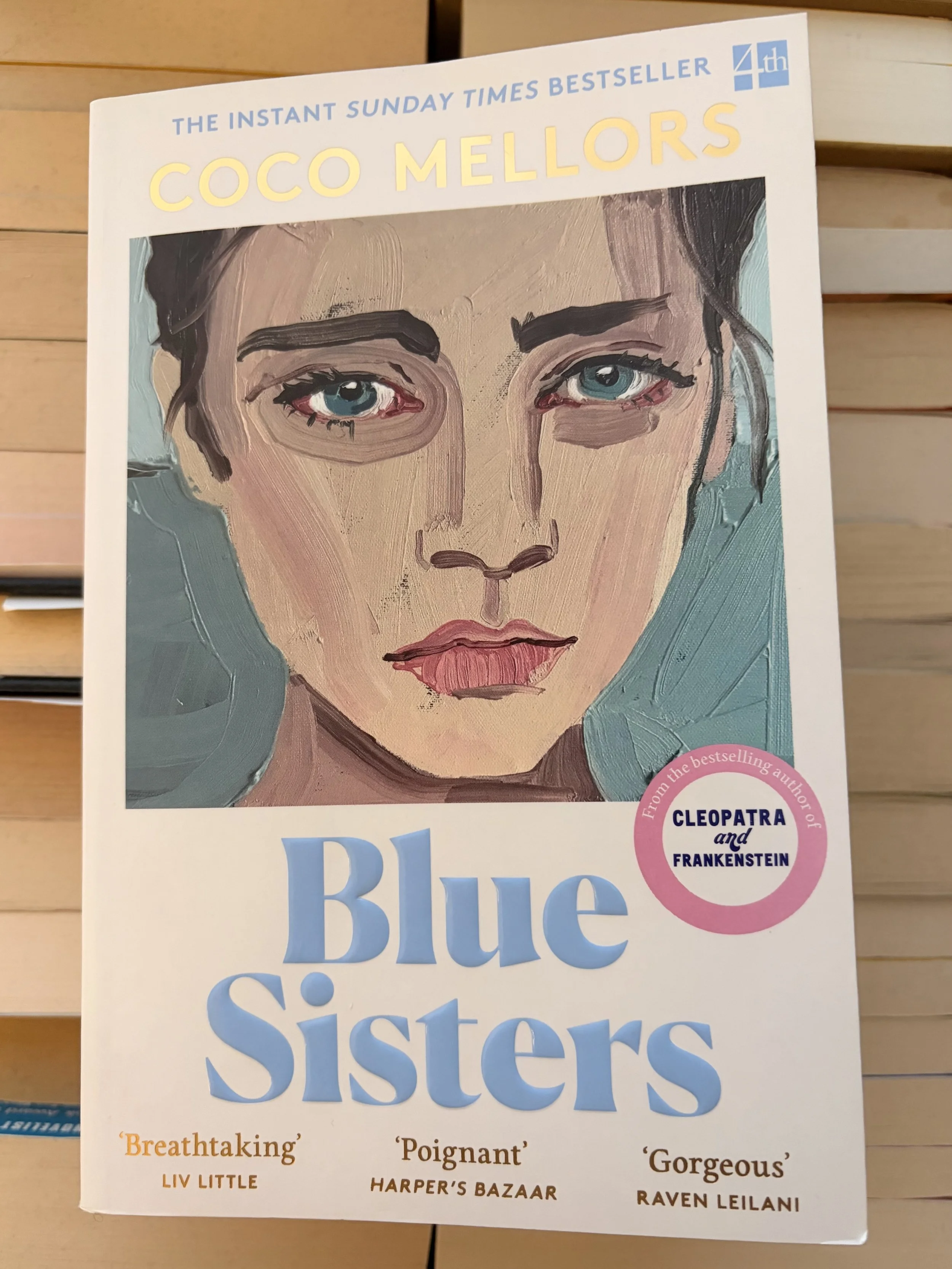 Blue Sisters sitting on top of books