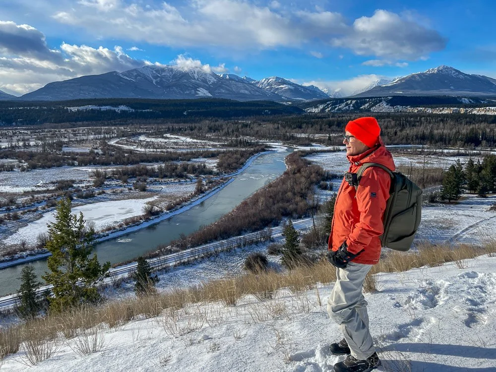 Marlene looking over an expansive landscape with a PGYTECH camera backpack on