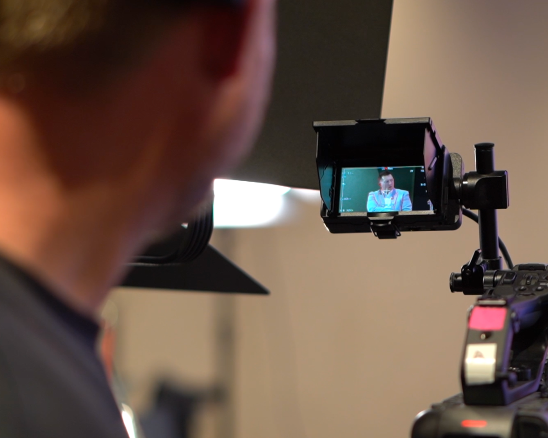 A camera operator manning a camera.