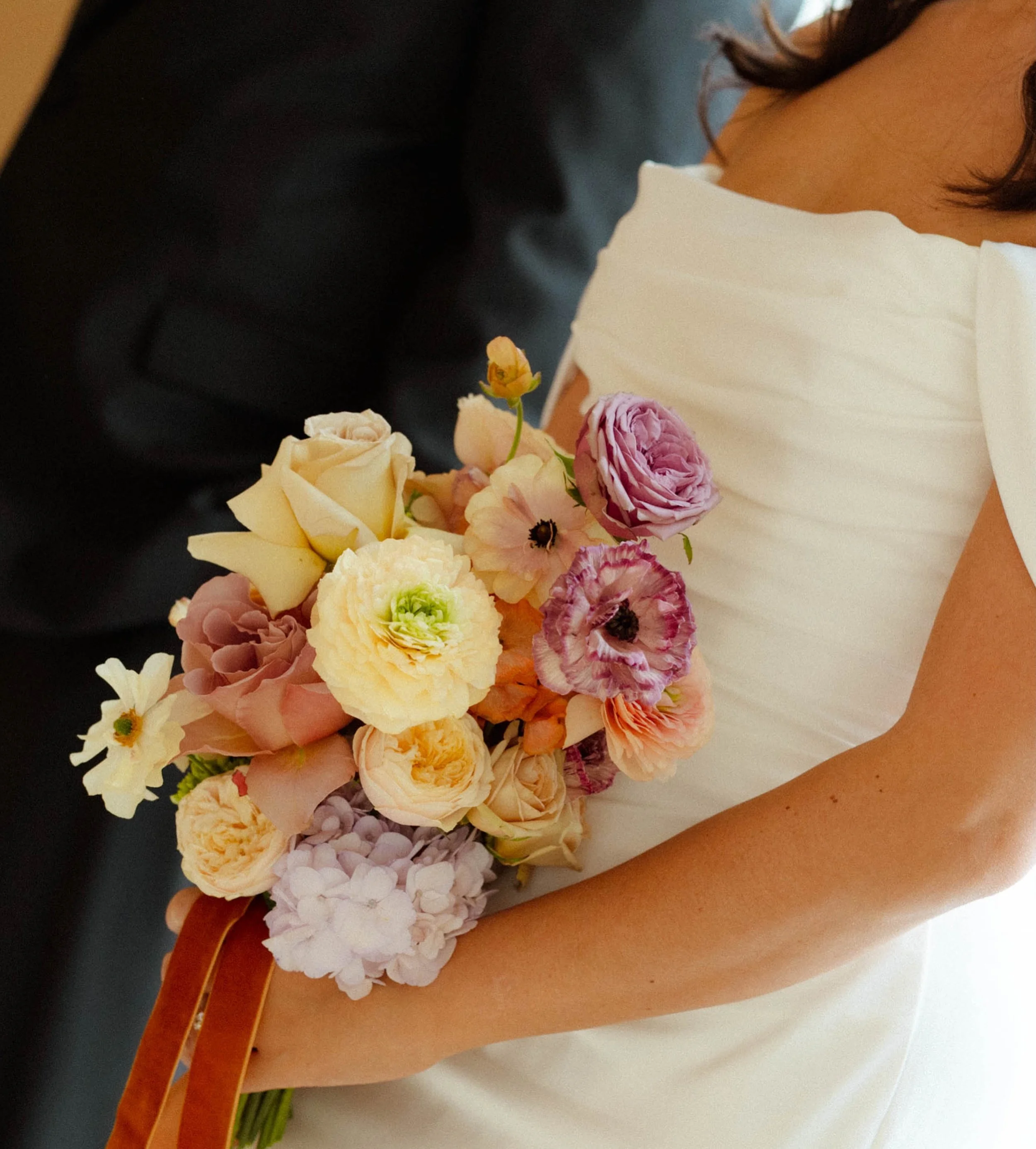 For Amy + Jeff, it was all about those juicy vintage tones. 

Enter peach, apricot, buttercream, and mauve, all woven into floral pillars that transformed the ceremony space and a bouquet to add a touch of edge and softness to the most elegant dress.